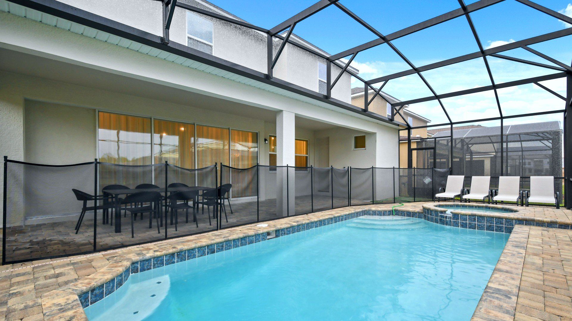 Relax by the private pool and spa in this screened patio with dining and loungers!