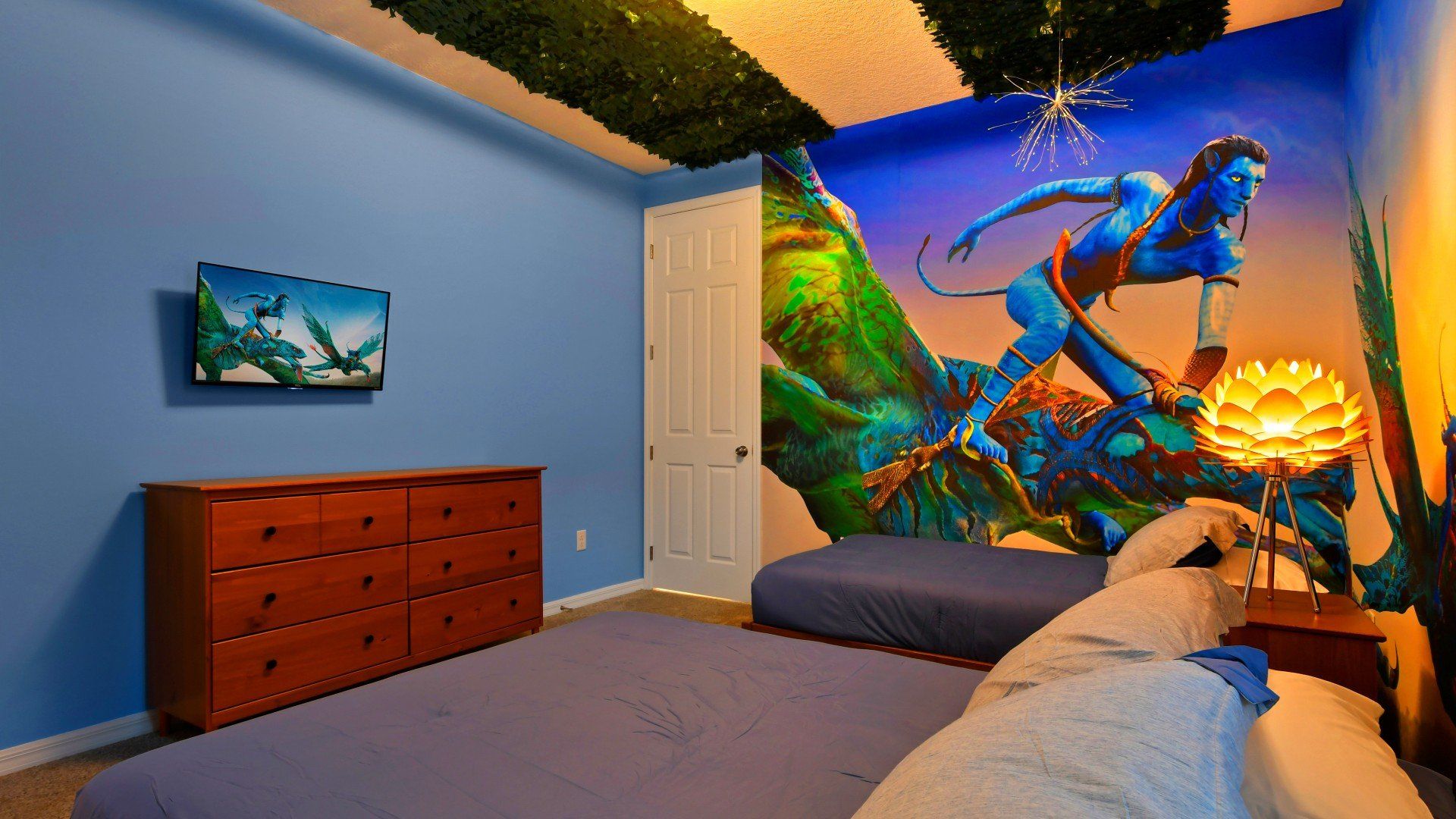 Immerse yourself in this stunning Avatar-themed bedroom with glowing decor and vibrant artwork!