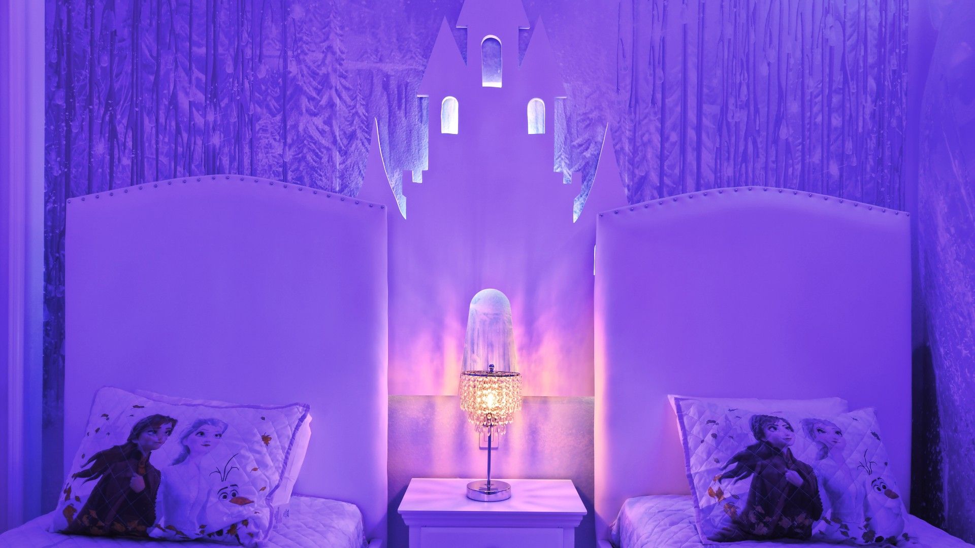 Enchanting Frozen-themed bedroom with glowing castle decor and cozy twin beds!