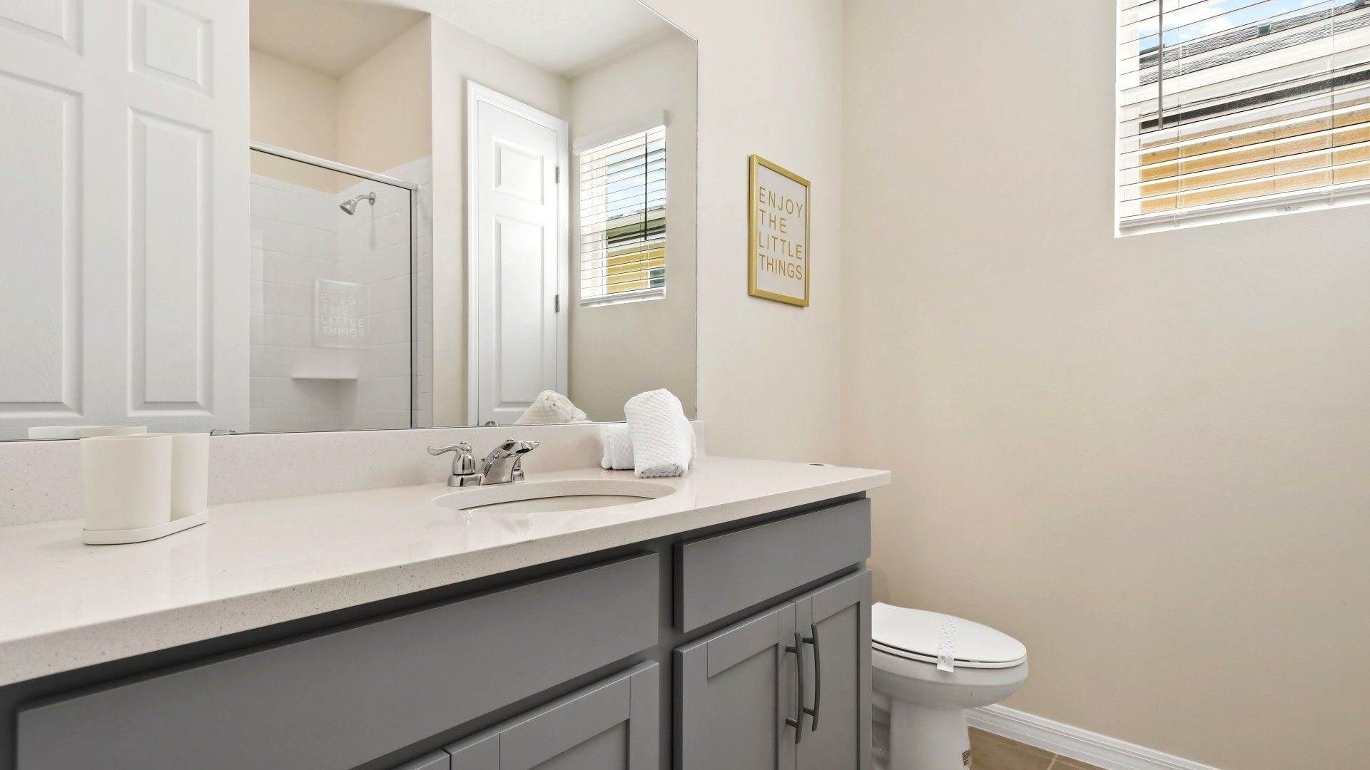 Chic and cozy bathroom with sleek finishes, natural light, and modern decor.