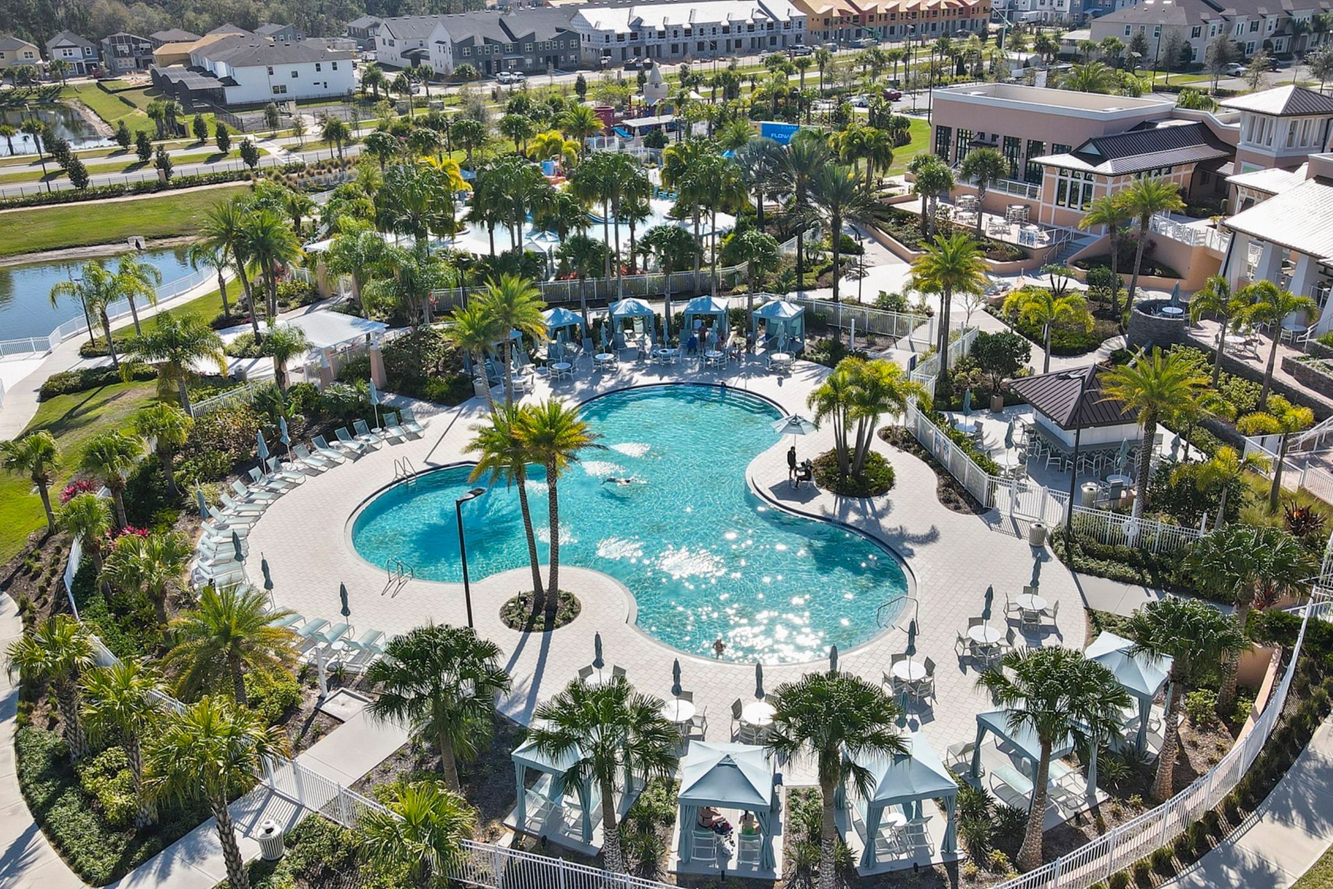 Relax in a sparkling resort pool surrounded by palm trees & cabanas!