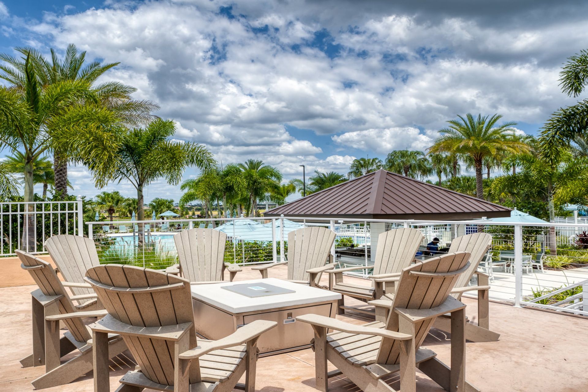 Unwind by the fire pit with stunning resort views and palm trees!