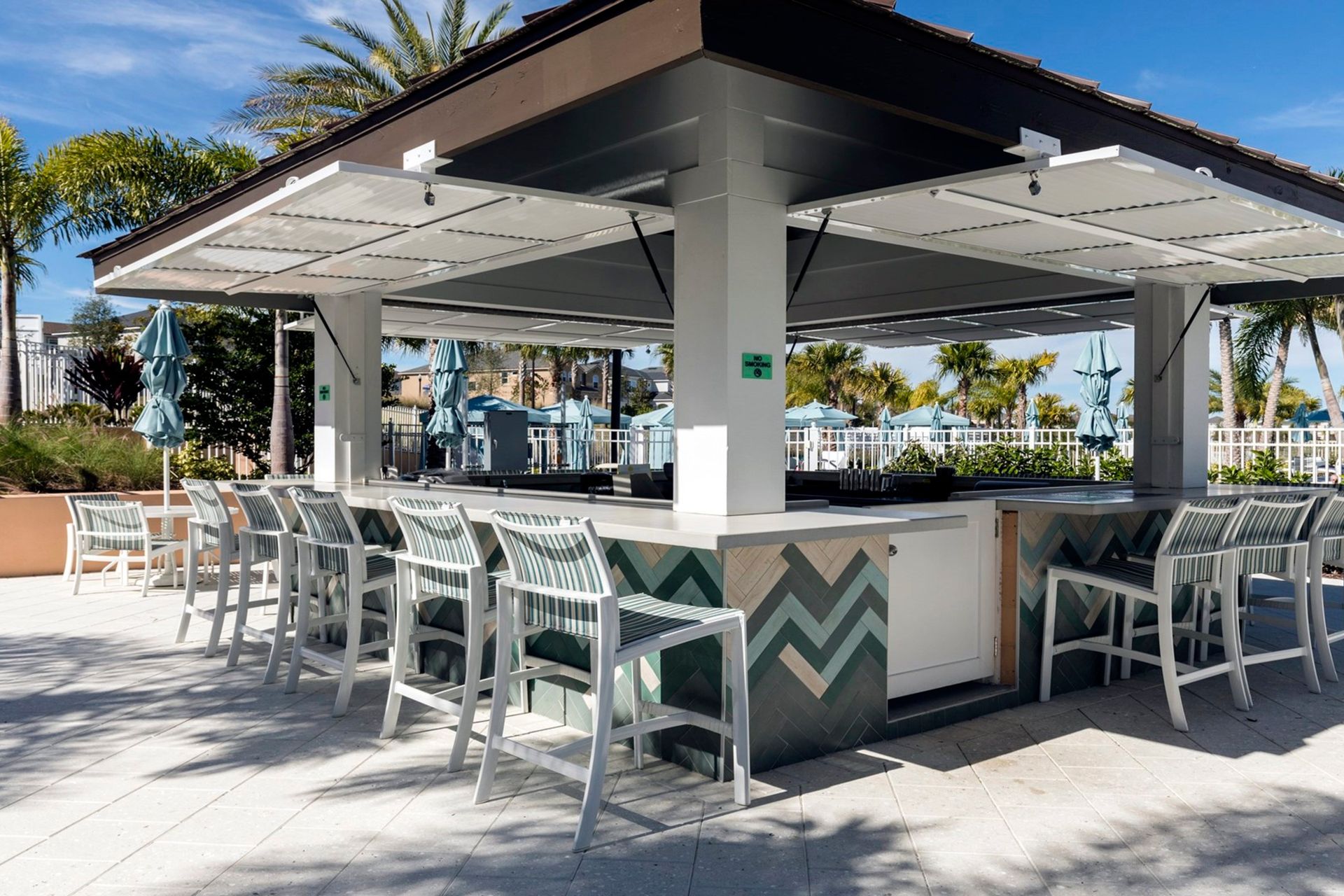 Poolside bar with stylish seating, perfect for tropical refreshments!