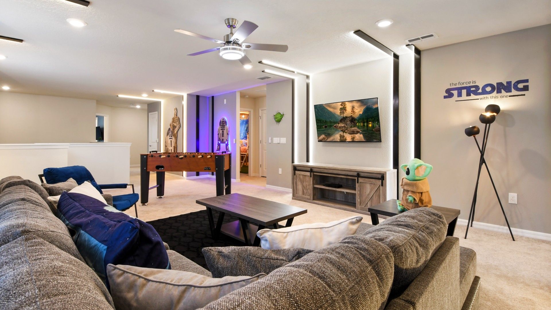 Spacious Star Wars-themed loft with foosball, cozy seating, and smart TV setup.