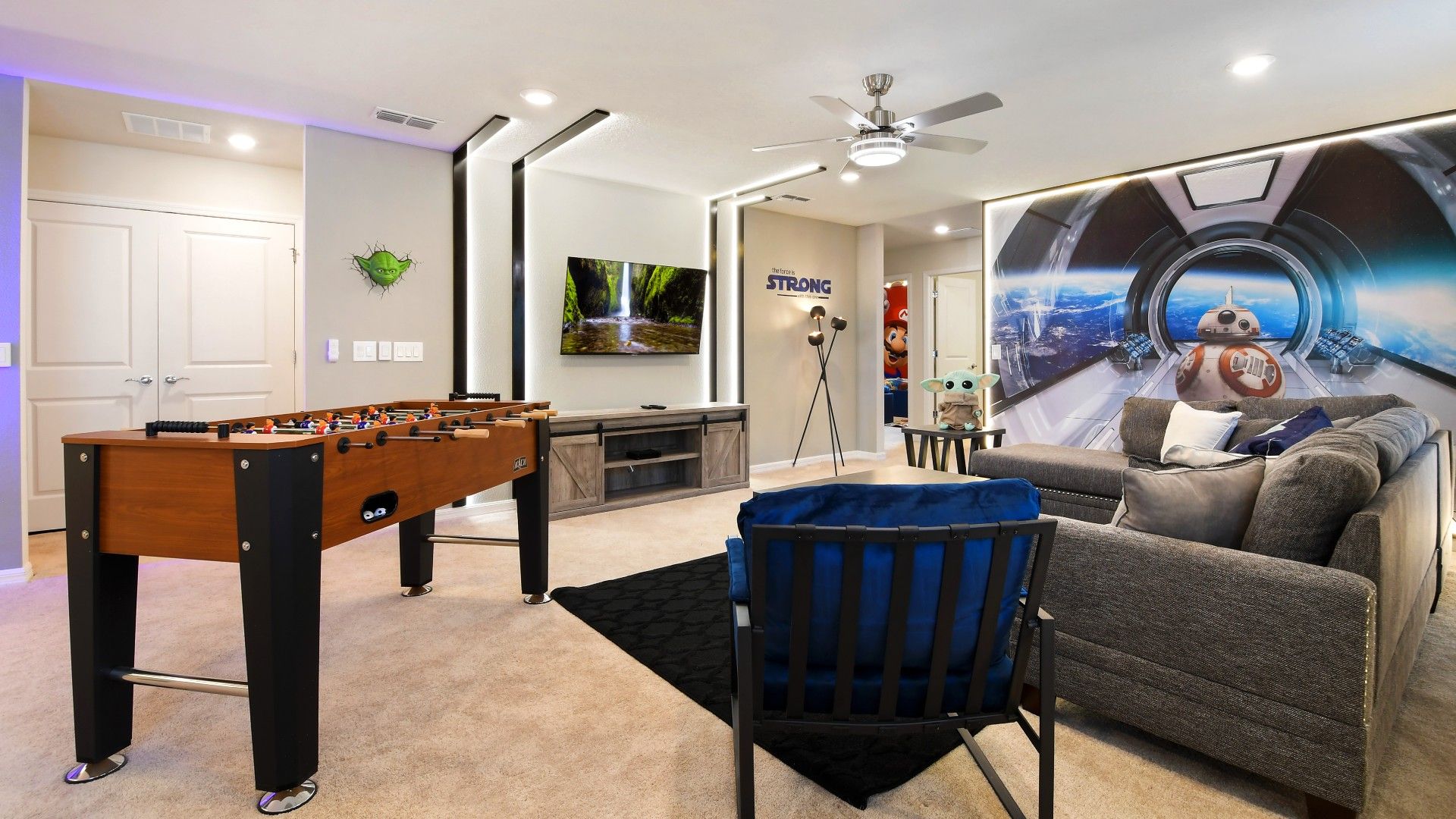 Epic sci-fi game room with foosball, big screen TV, and out-of-this-world decor.