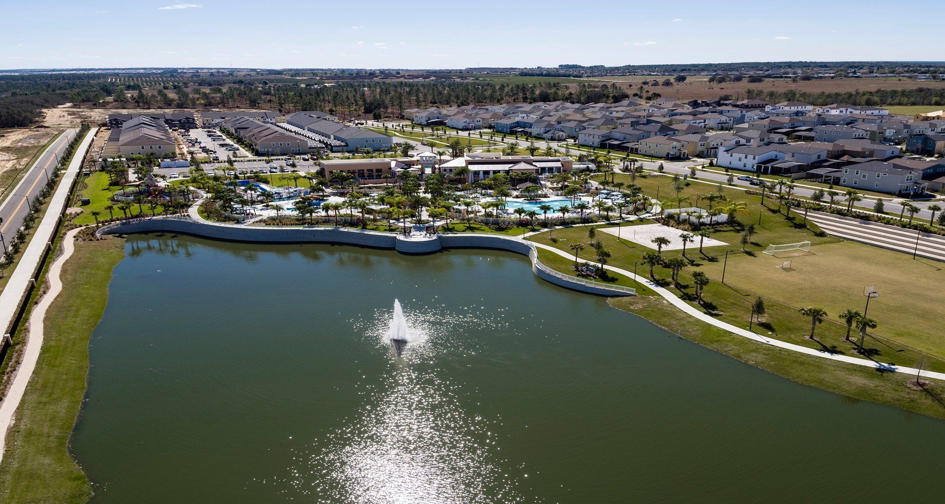 Expansive aerial view of luxury resort with pools, lake & sports!