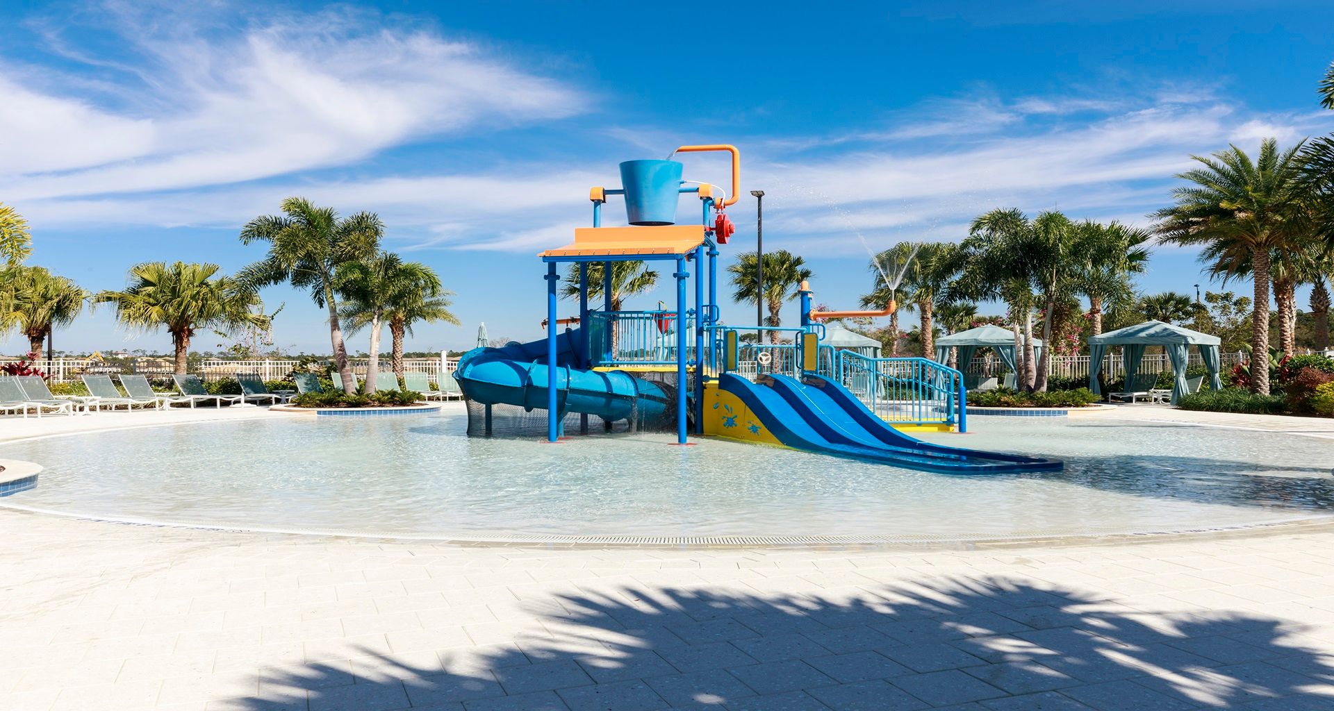 Resort-style kids' splash zone with slides, water fun, and cabanas!