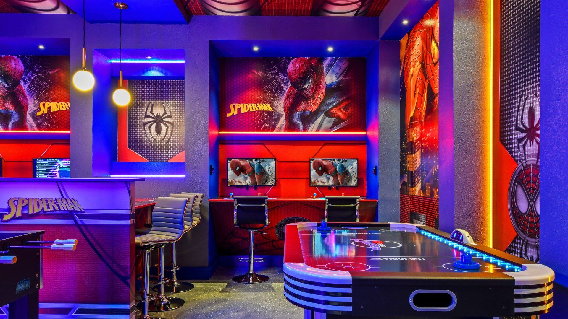 Exciting superhero game room with air hockey, gaming stations, and themed decor.