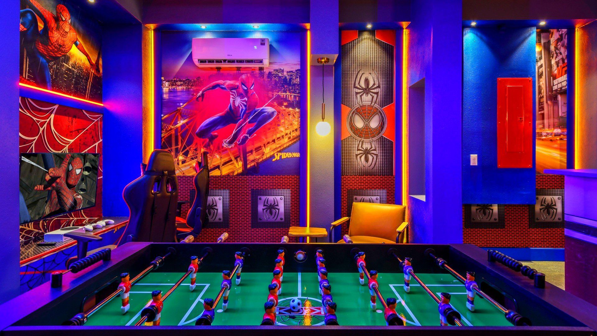 Dynamic superhero-themed game room with foosball, gaming setup, and vibrant lighting.