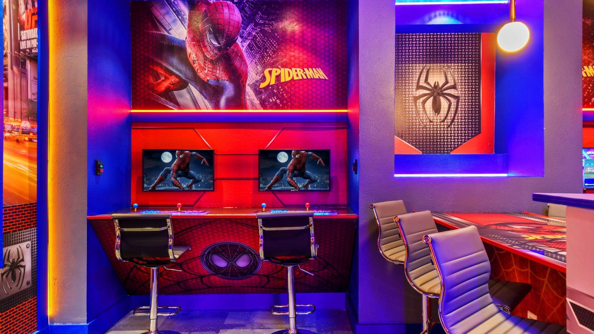 Vibrant superhero gaming corner with dual screens, sleek chairs, and themed decor.