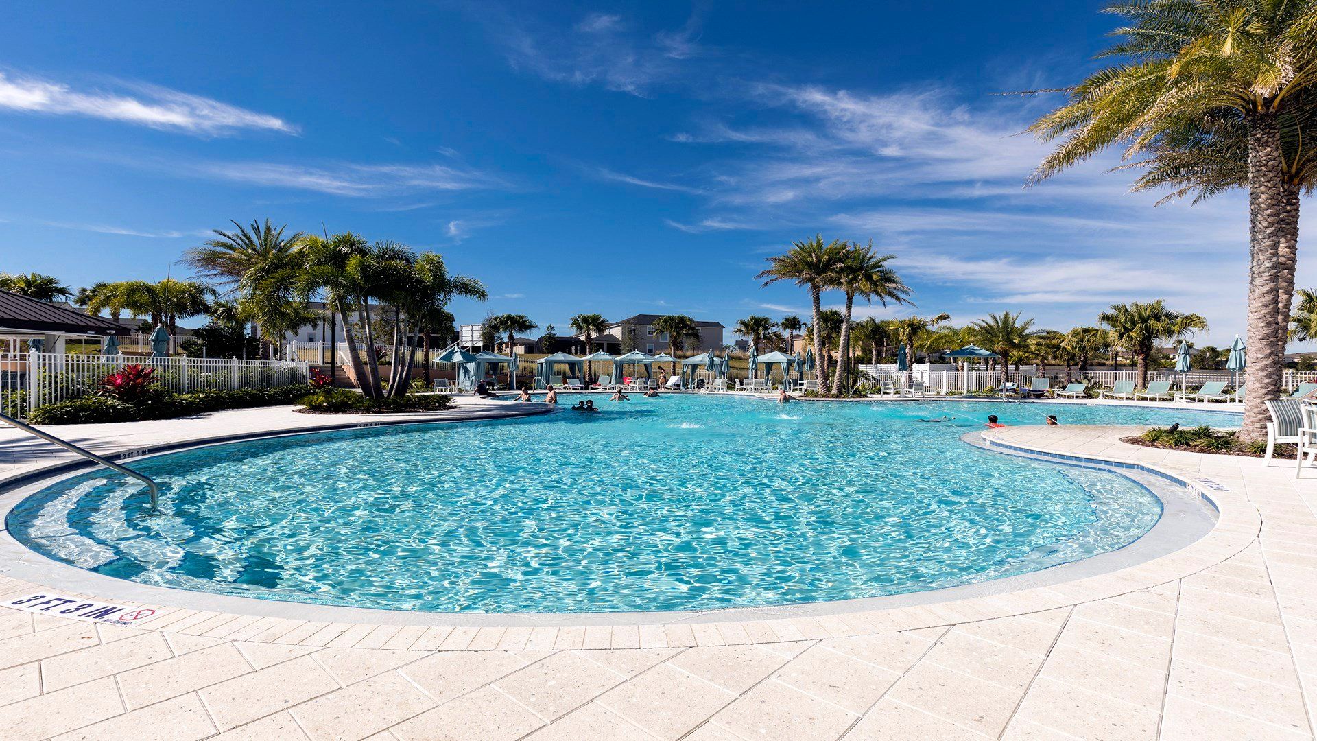 Resort-style pool with palm trees, cabanas, and plenty of sunshine—a perfect retreat near Disney!