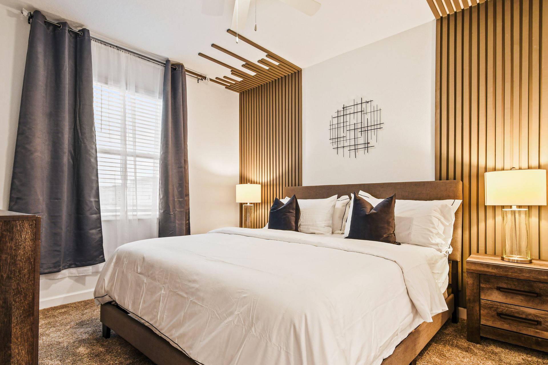 The master bedroom features a luxuriously large king bed with a crib