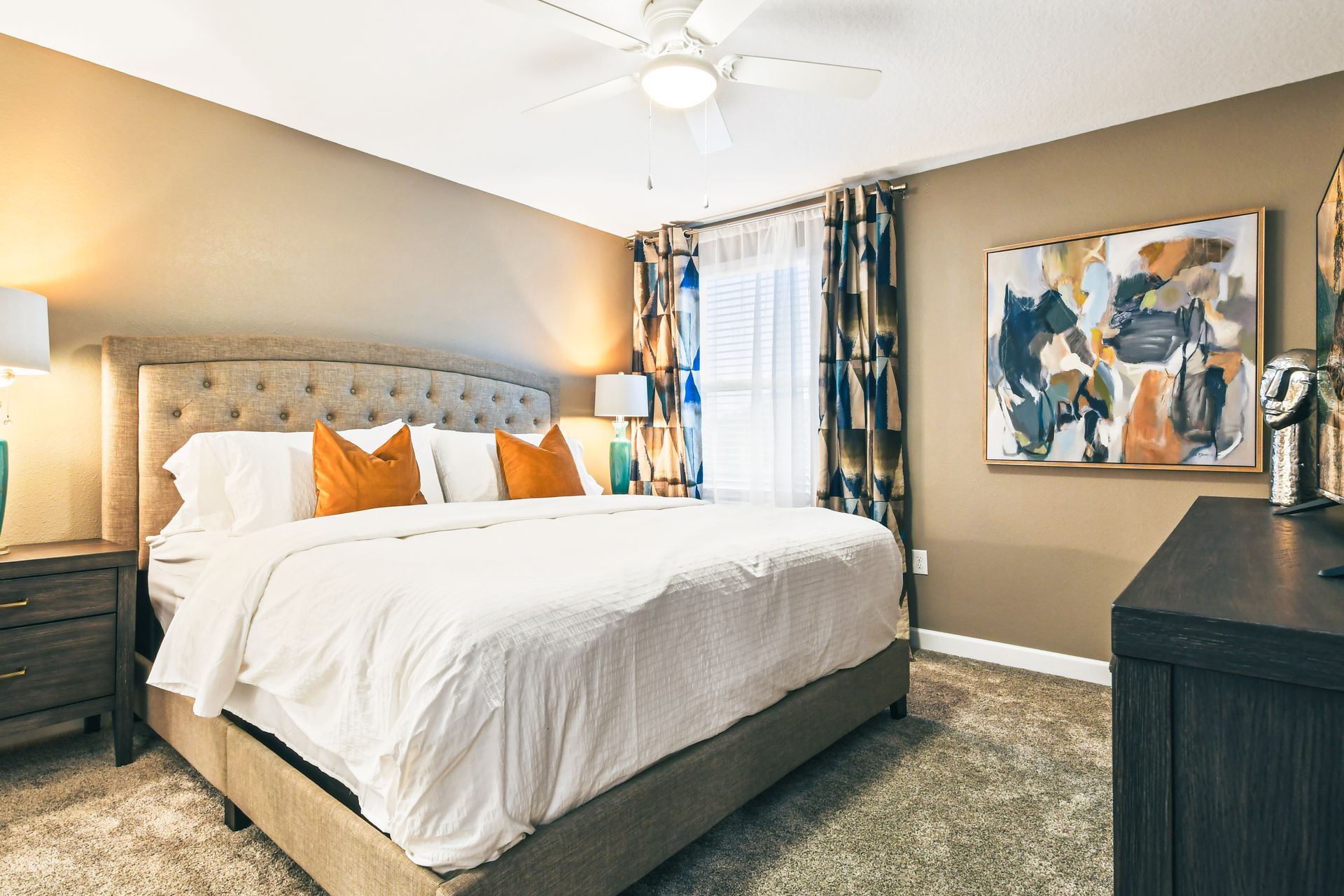 Warm and inviting bedroom with king bed, bold decor, and cozy modern touches