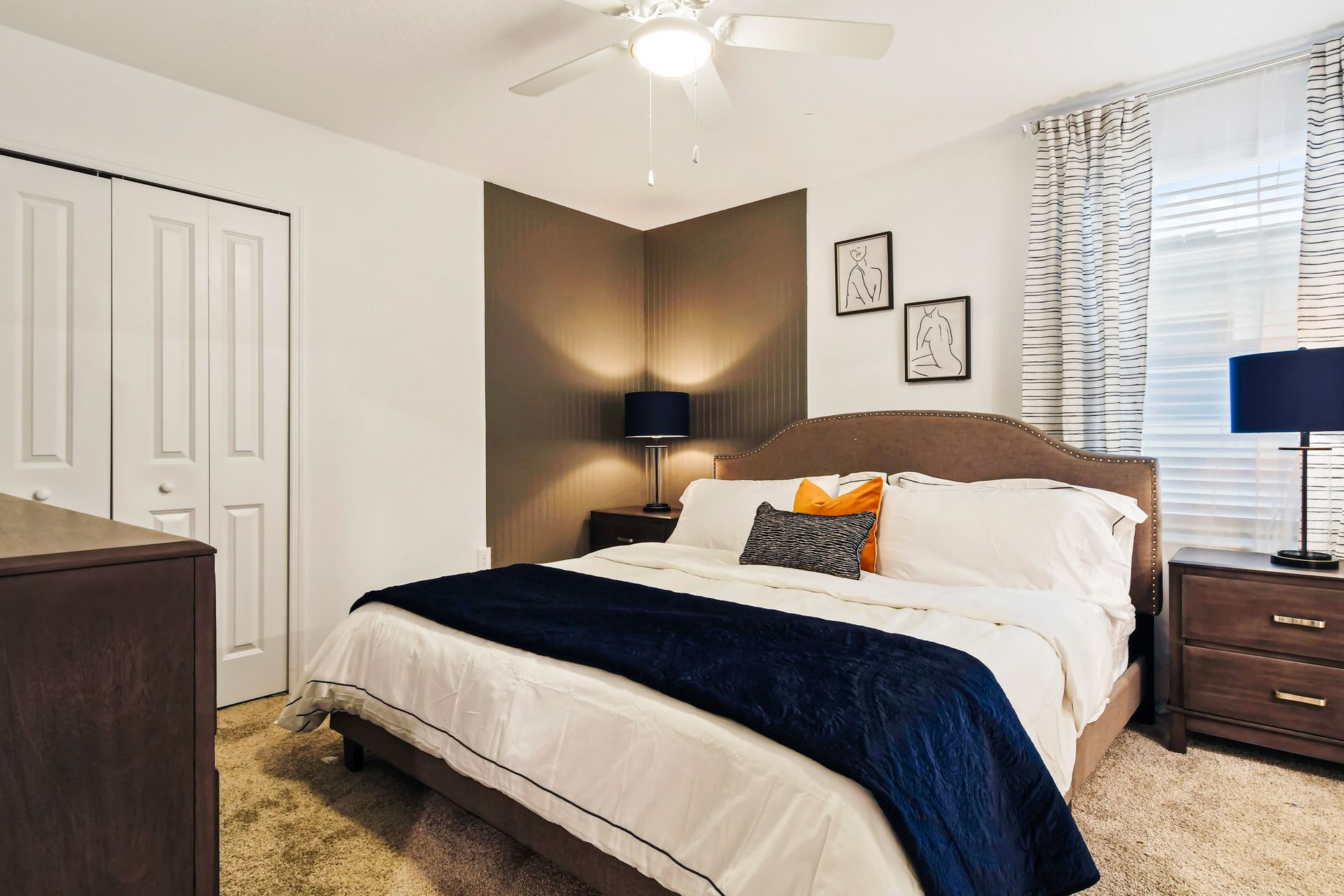 Chic bedroom with bold accents, cozy bedding, and plenty of natural light