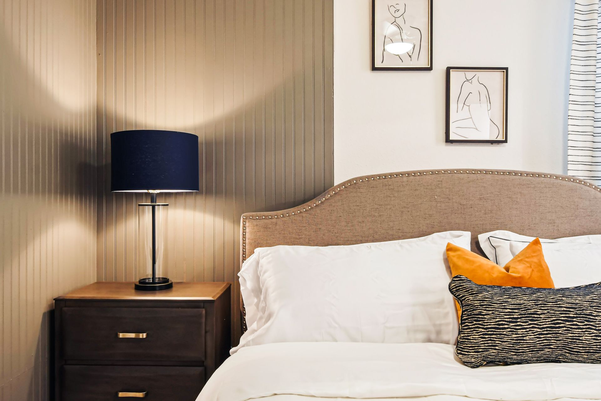 Stylish bedroom nook with warm lighting, elegant textures, and artistic flair