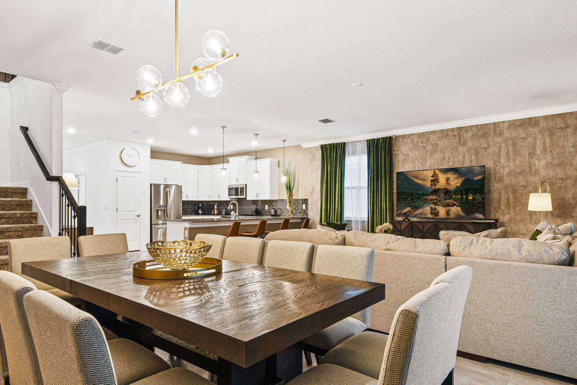 Open-concept living with modern kitchen, spacious dining, and cozy lounge area