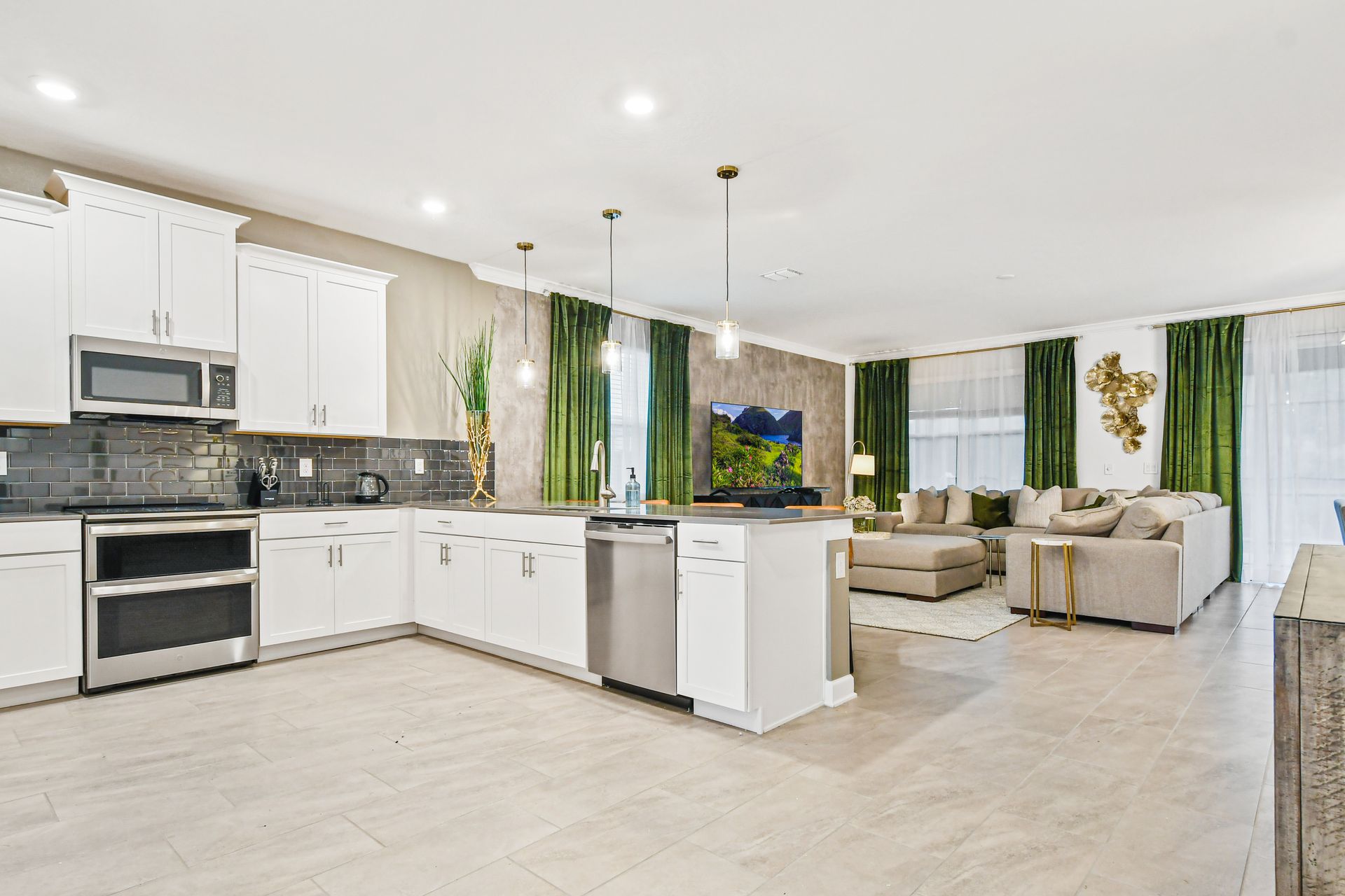 Bright open kitchen with sleek finishes, island seating, and connected living space