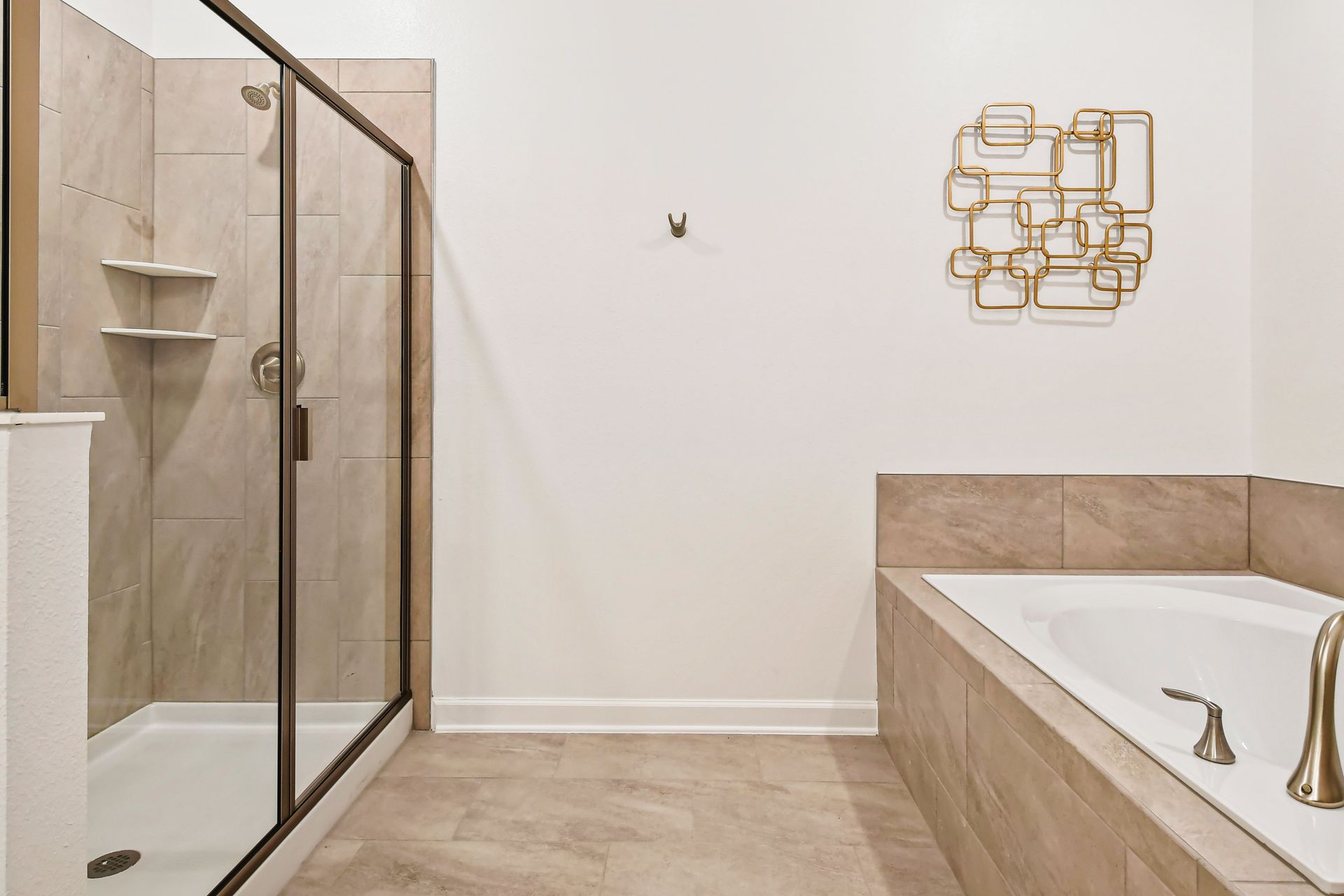 Luxury bath with walk-in shower, soaking tub, and sleek gold hardware finishes