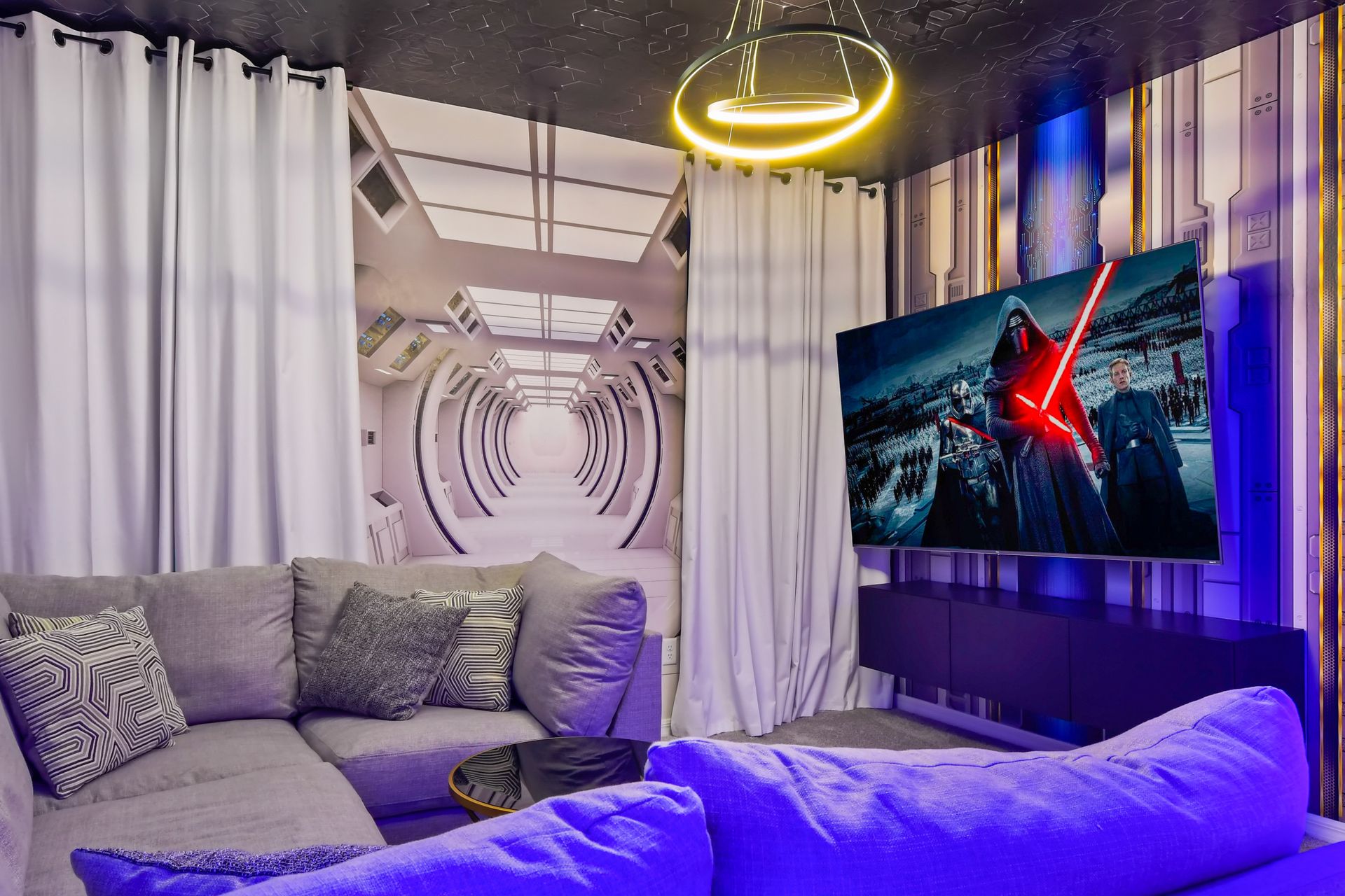 Immersive sci-fi media room with plush seating, futuristic decor, and vibrant lighting.