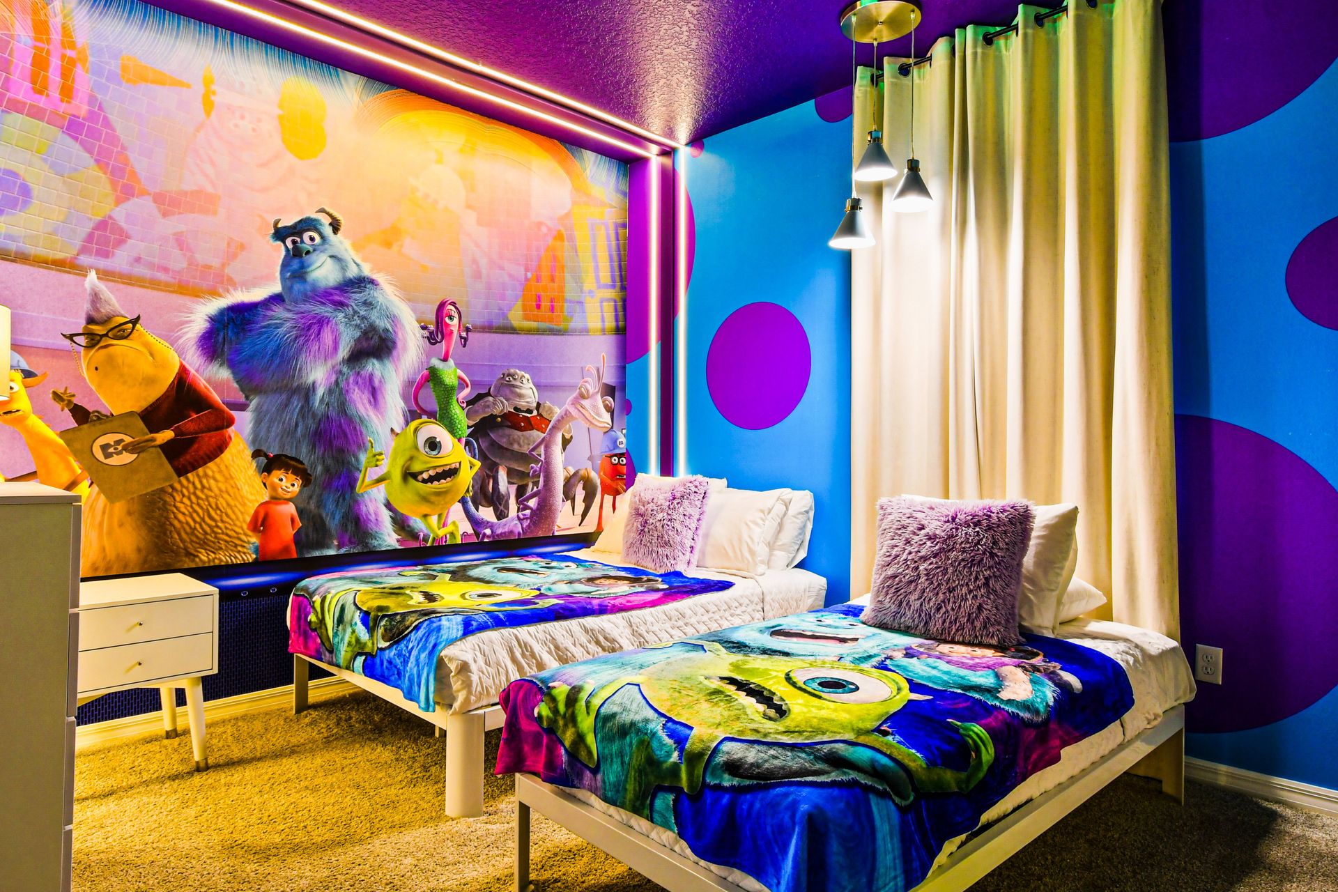 Colorful kids' room with twin beds, playful decor, and themed bedding.