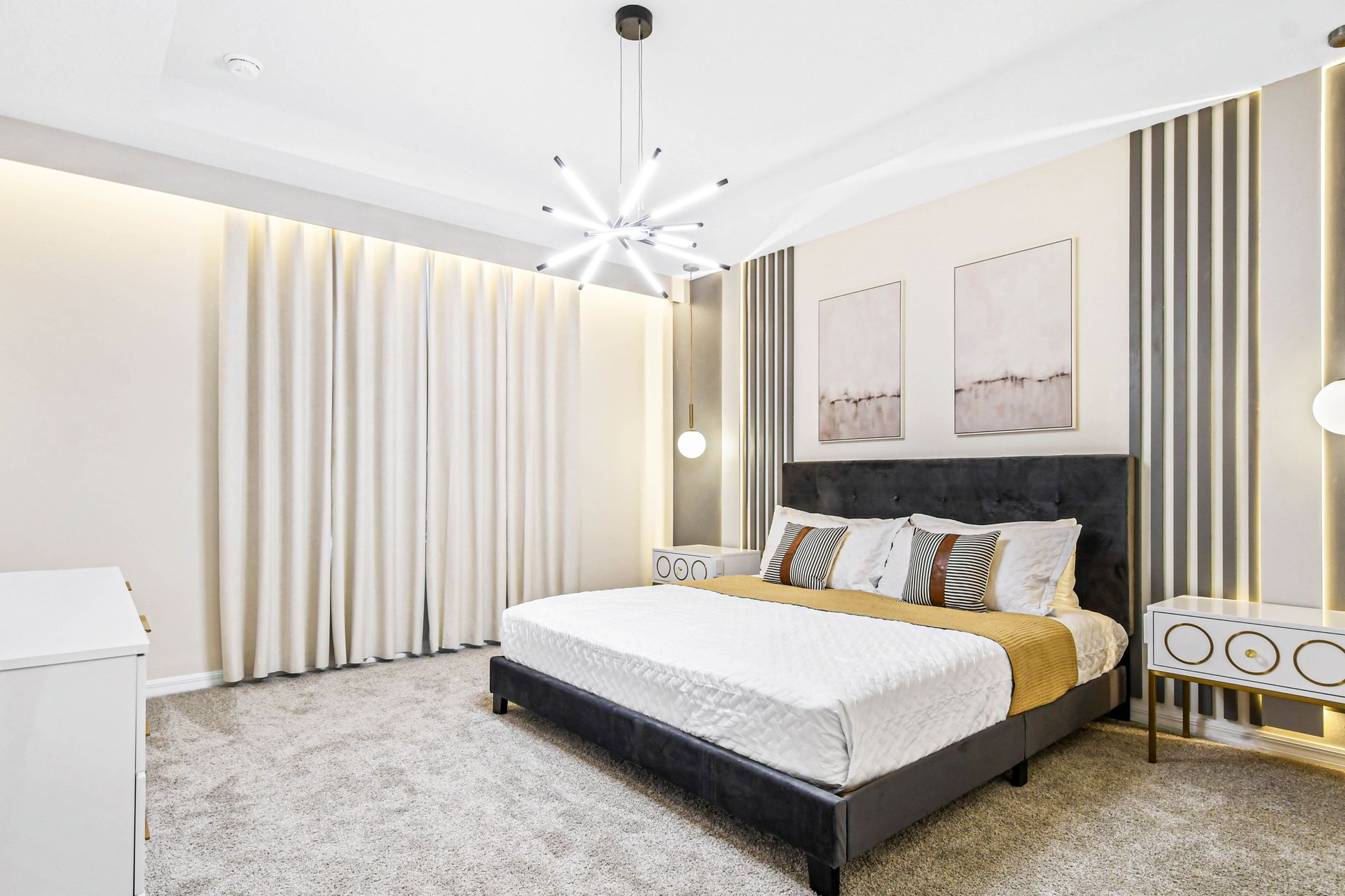 Modern bedroom with a sleek design, plush king bed, and stylish lighting.