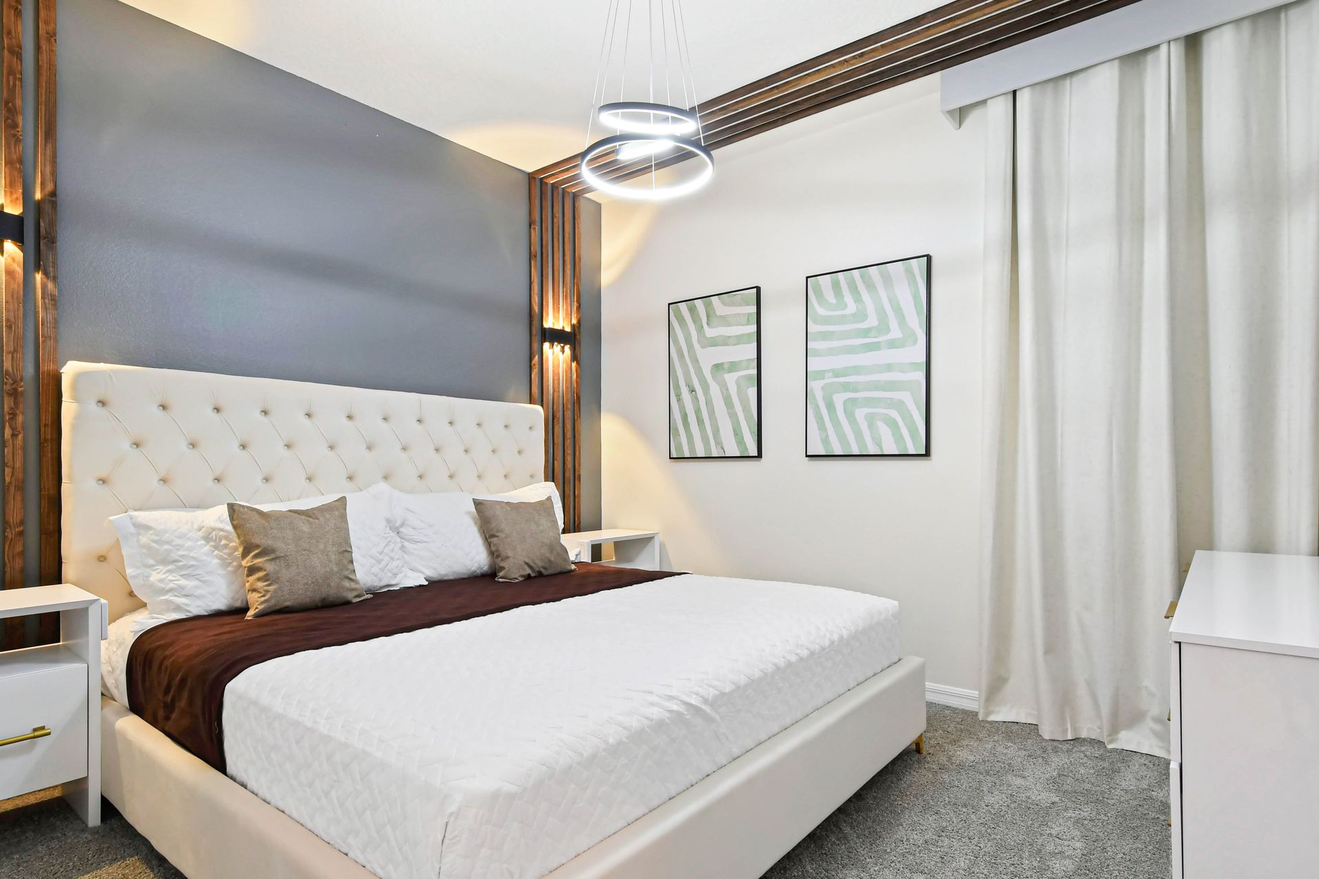 Queen-sized comfort with a TV, offering a cozy and entertainment-ready haven.