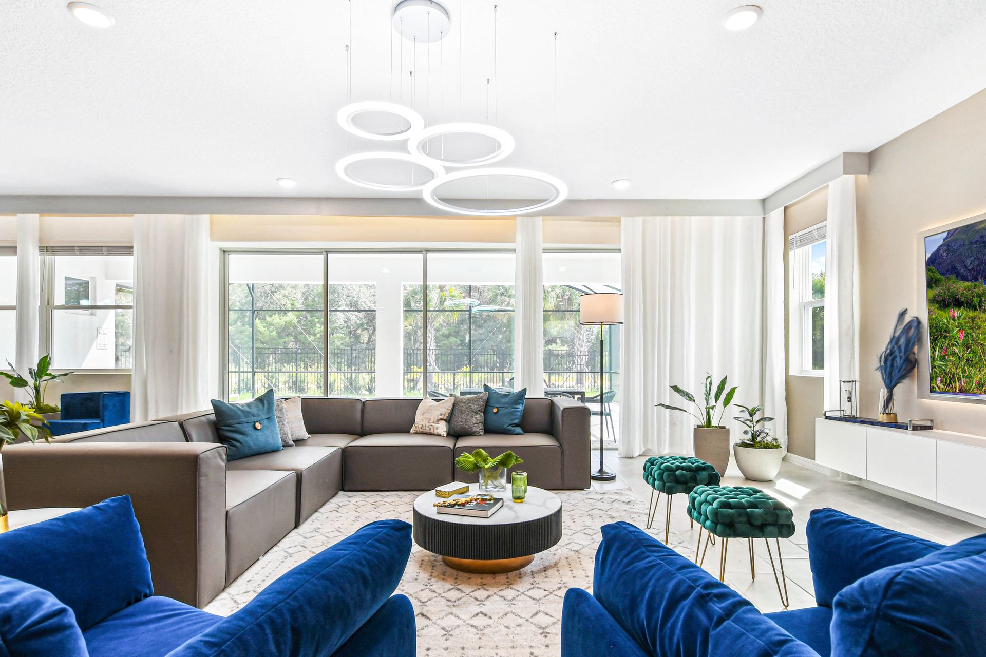 Stylish living room with plush seating, modern decor, and abundant natural light.
