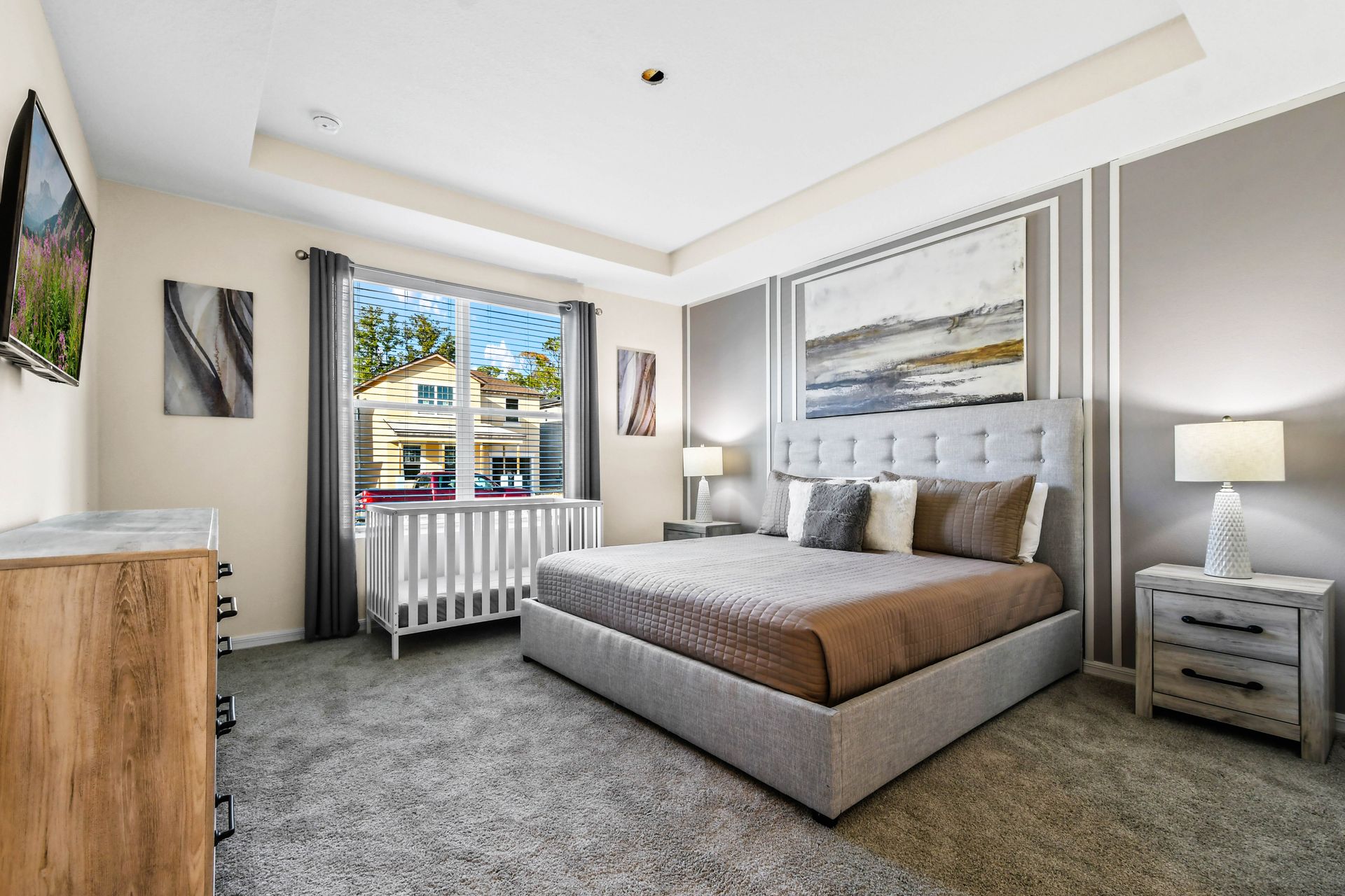 Spacious master bedroom with elegant decor, natural light, and crib!