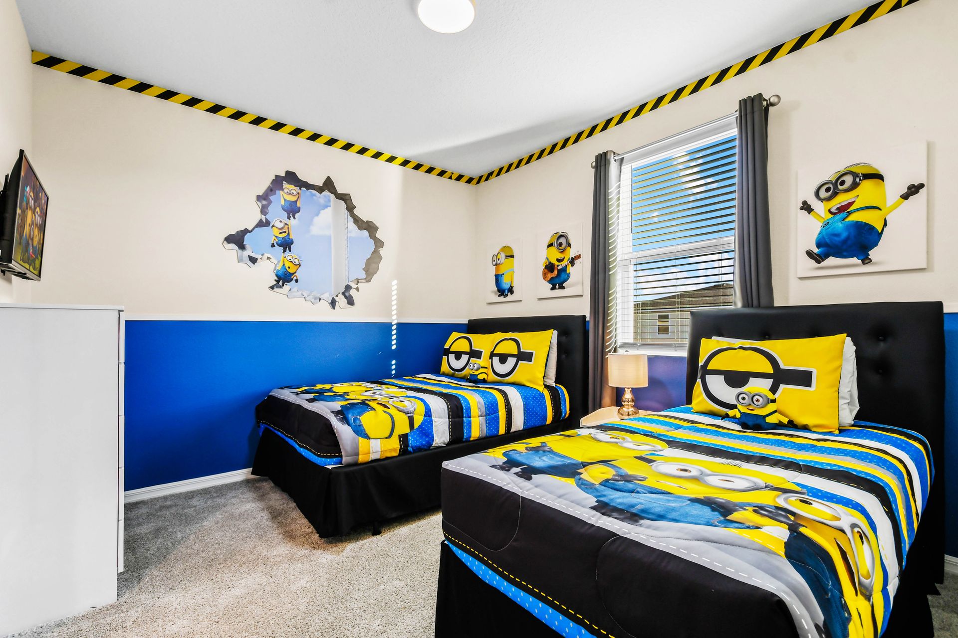 Playful Minions-themed bedroom with twin beds and vibrant decor!