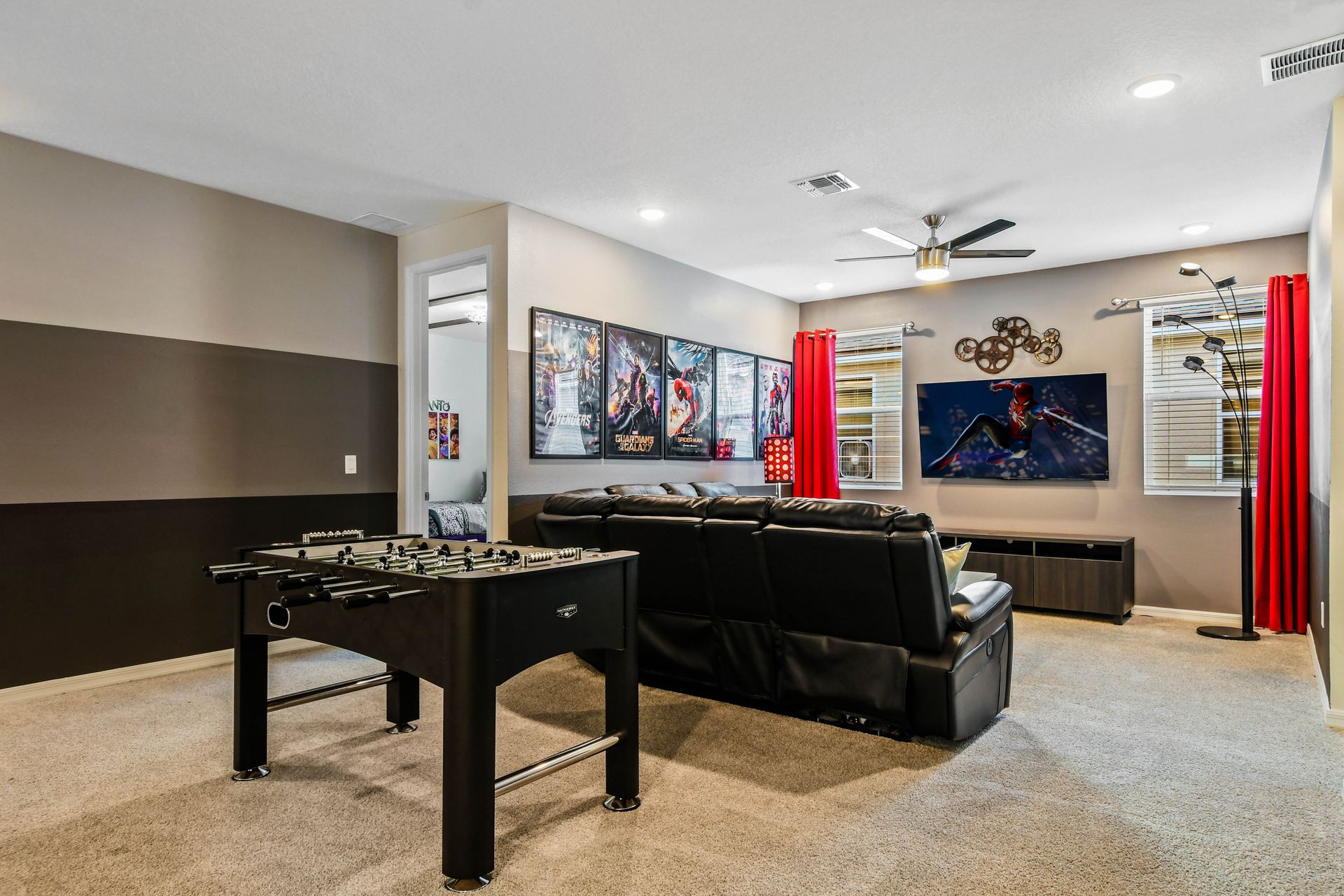 Fun entertainment room with theater seating, foosball, and big screen!