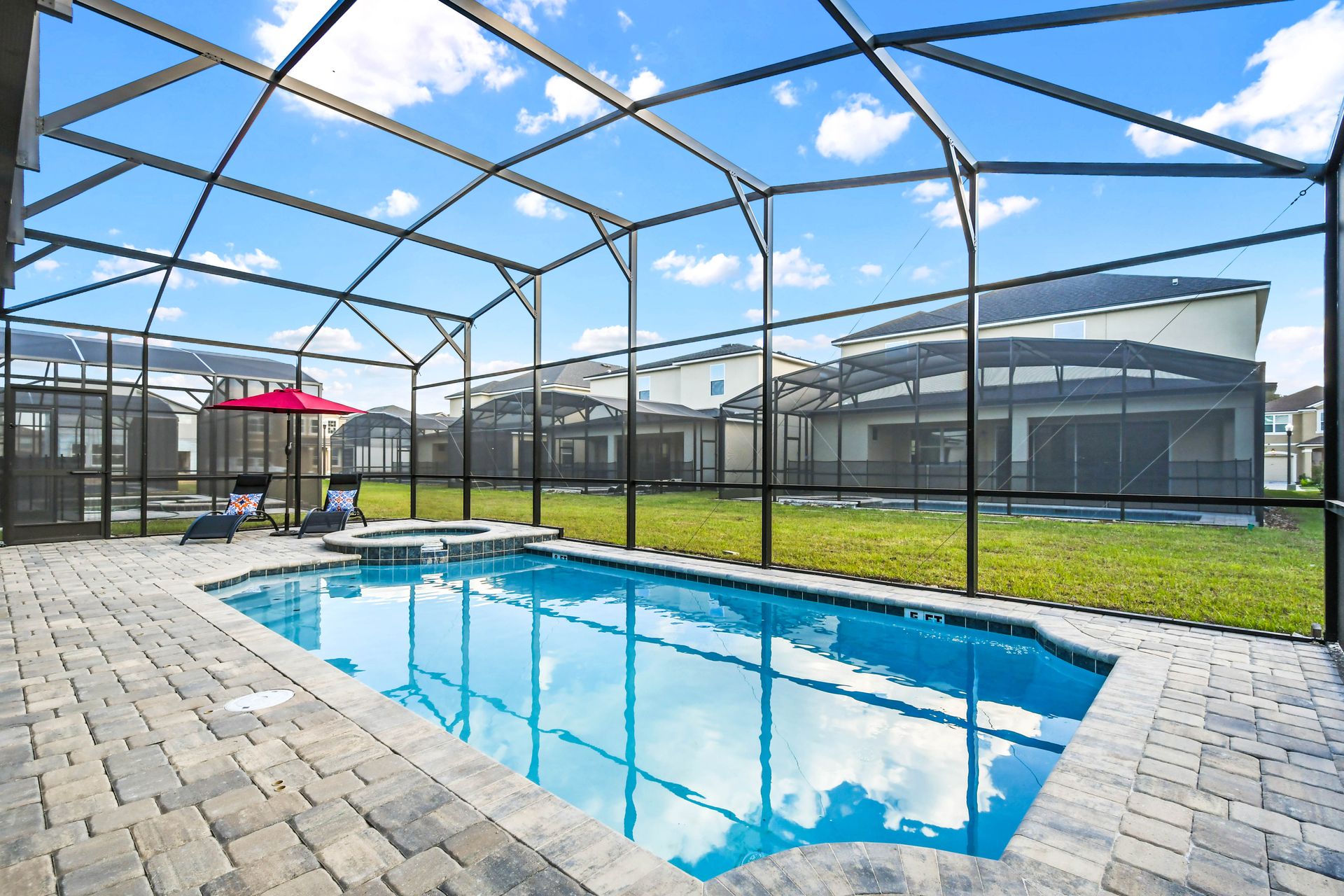 Spacious screened patio with pool, spa, dining area, and lounge seating!