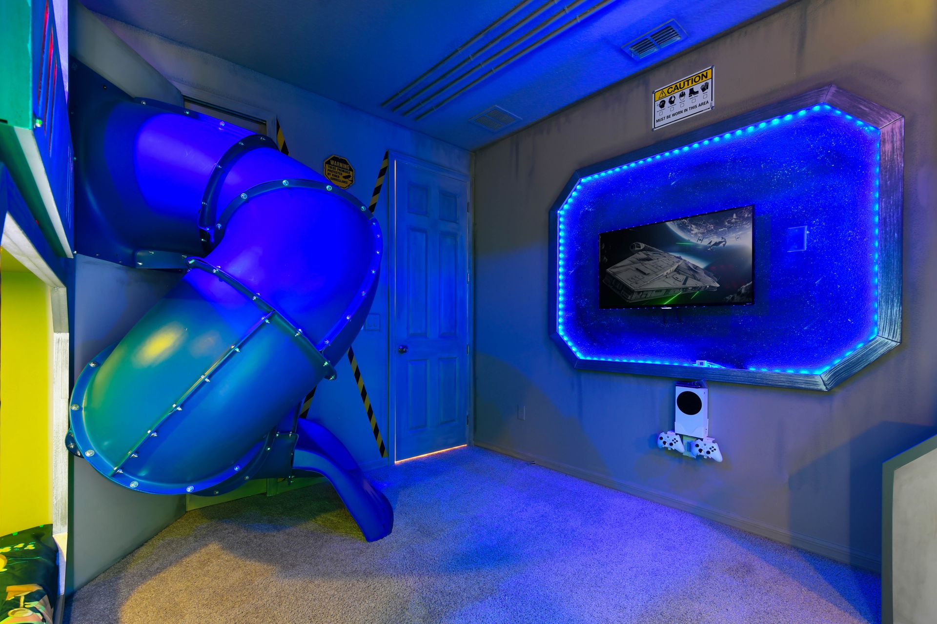 Immersive space-themed room with slide, gaming station, and LED lights!