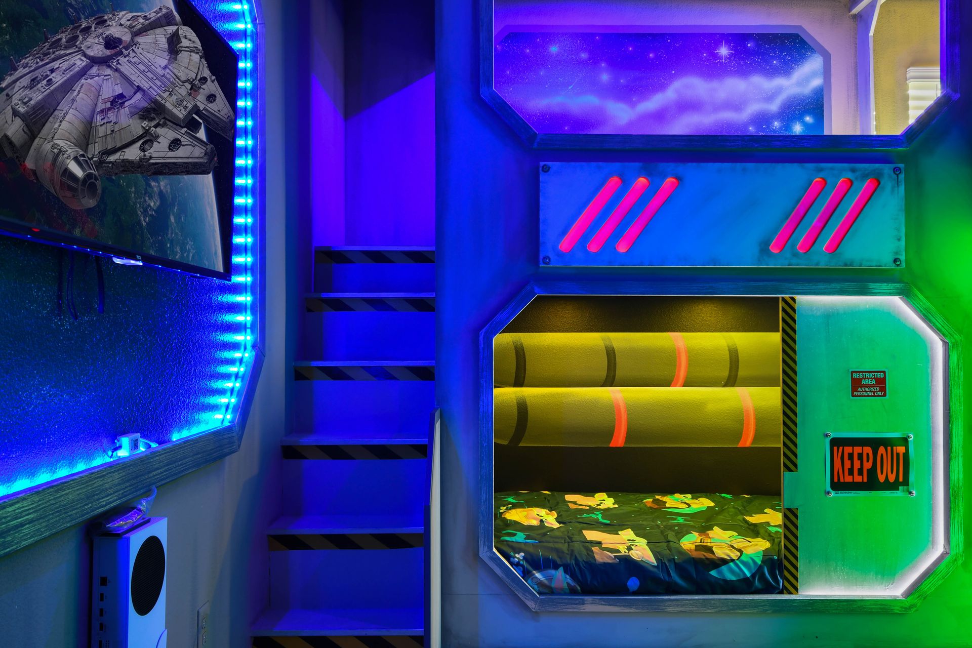 Futuristic space-themed bunk room with glowing lights and slides