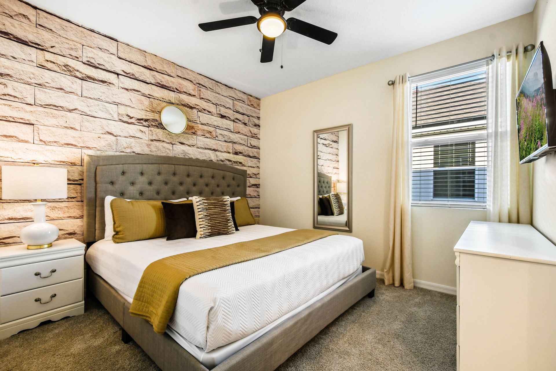 Cozy bedroom with a rustic stone accent wall and soft lighting!