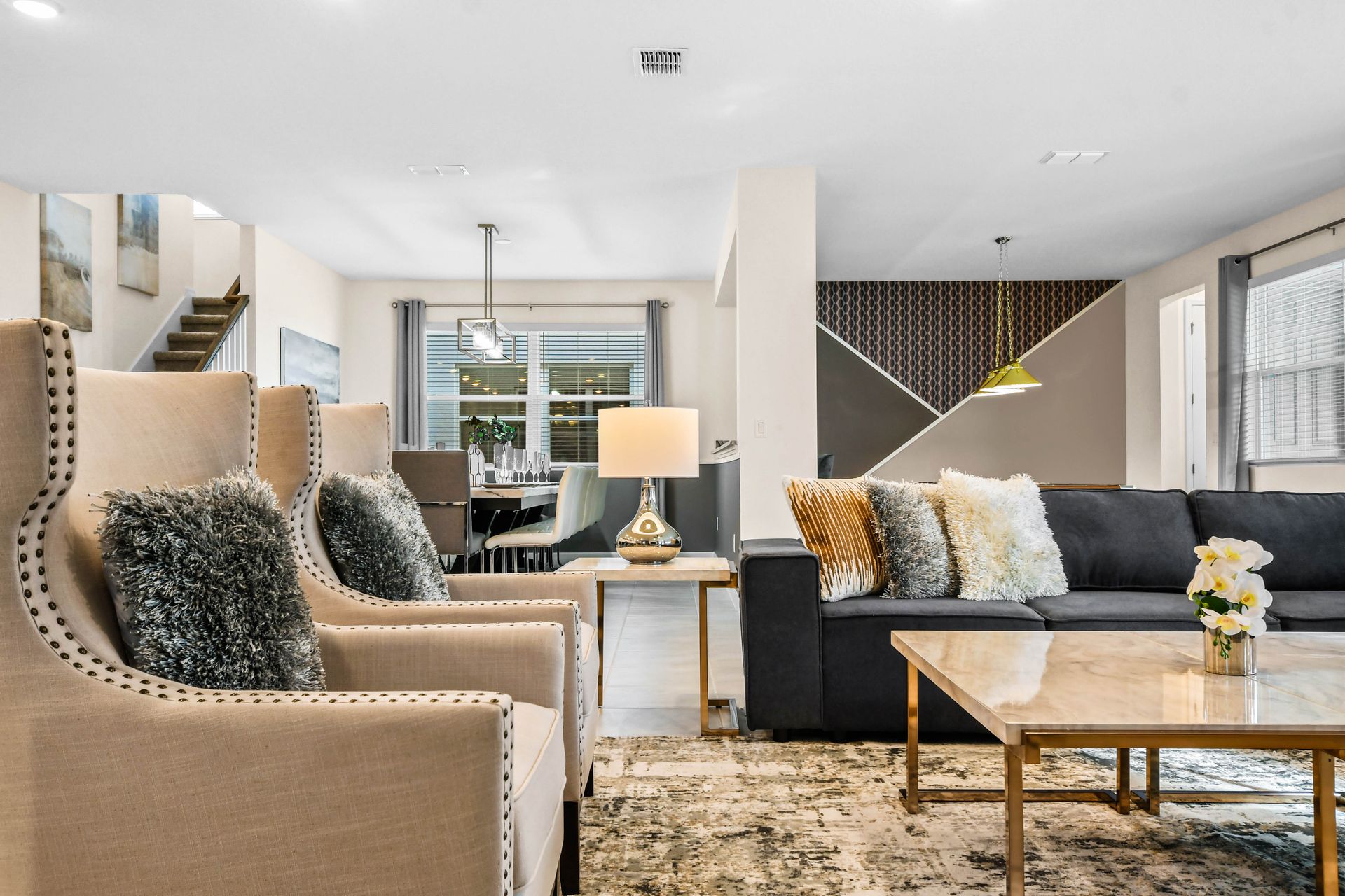 Spacious open-concept living area with chic furnishings and charm