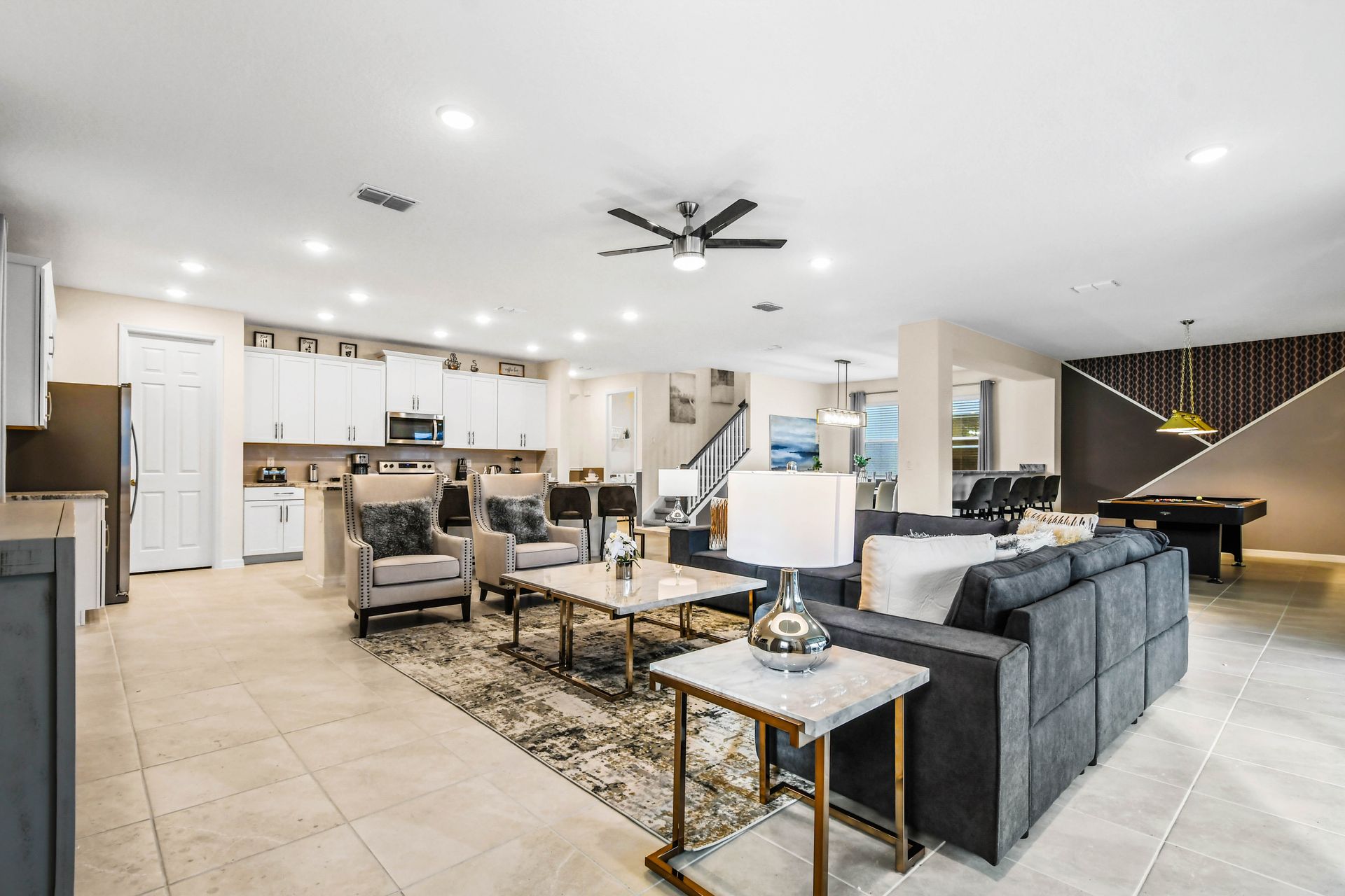 Spacious open-plan living with modern kitchen, lounge, and game area