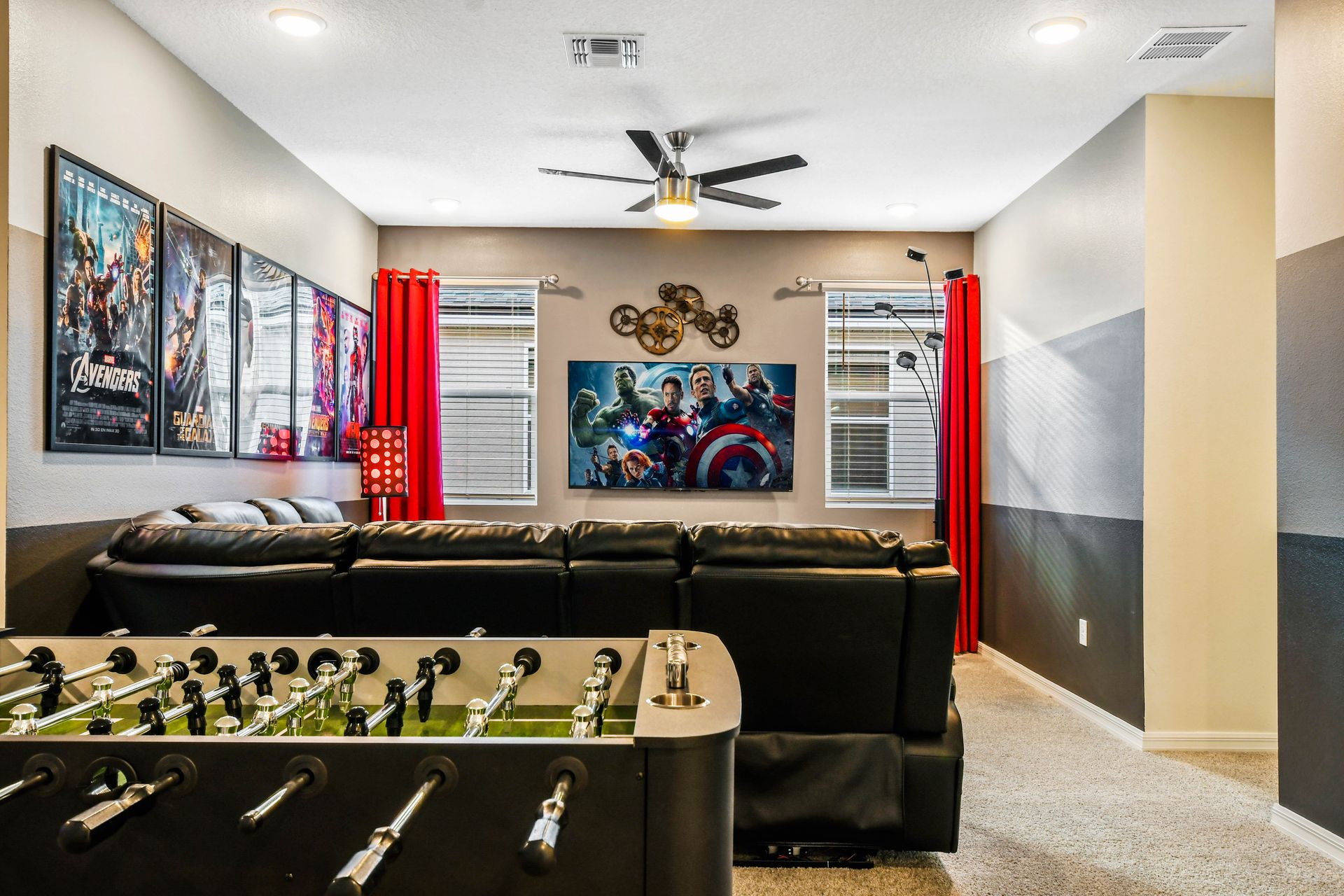 Fun entertainment room with theater seating, foosball, and big screen!