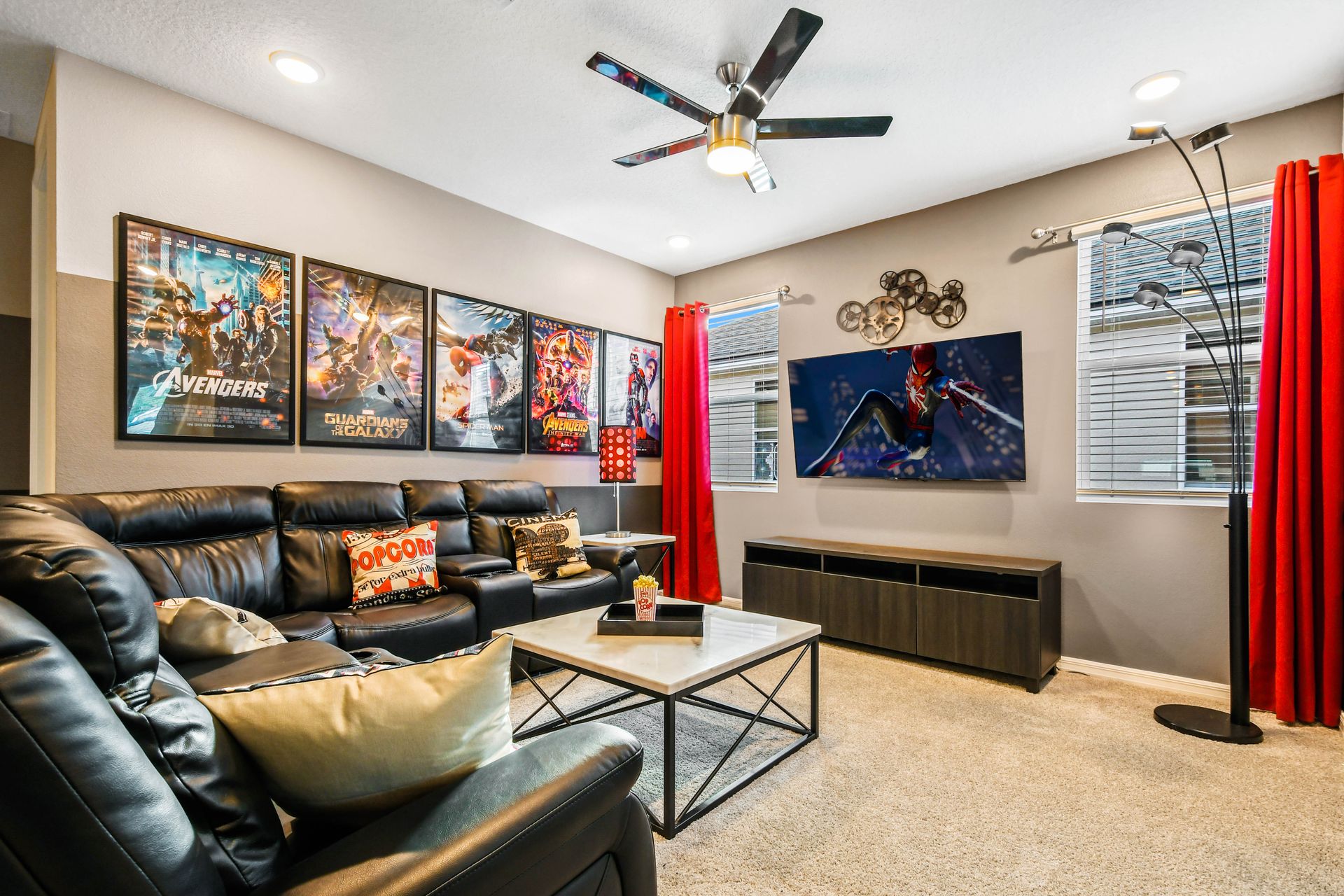 Epic home theater room with comfy seating, movie posters & TV