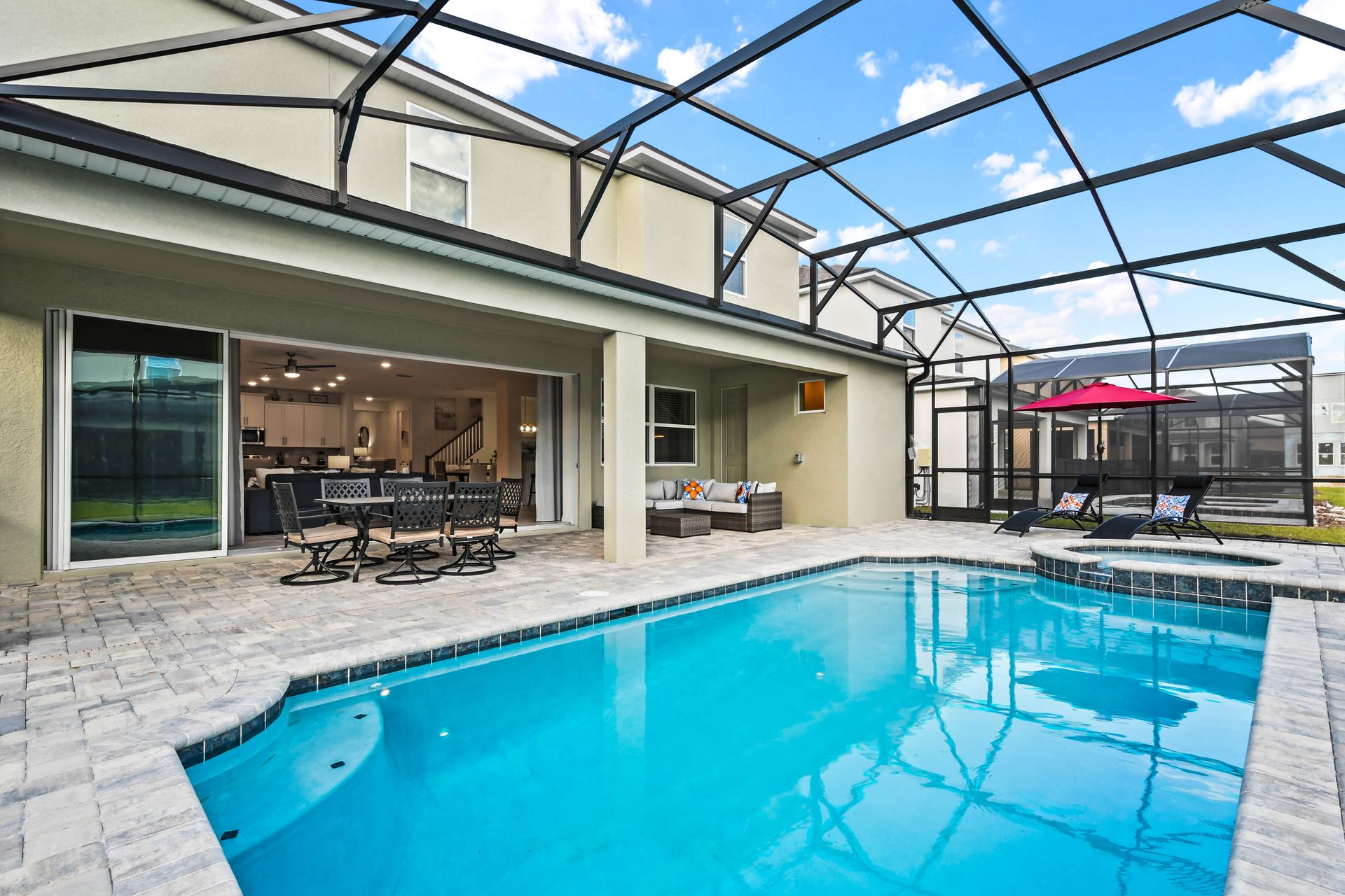 Spacious screened patio with pool, spa, dining area, and lounge seating!
