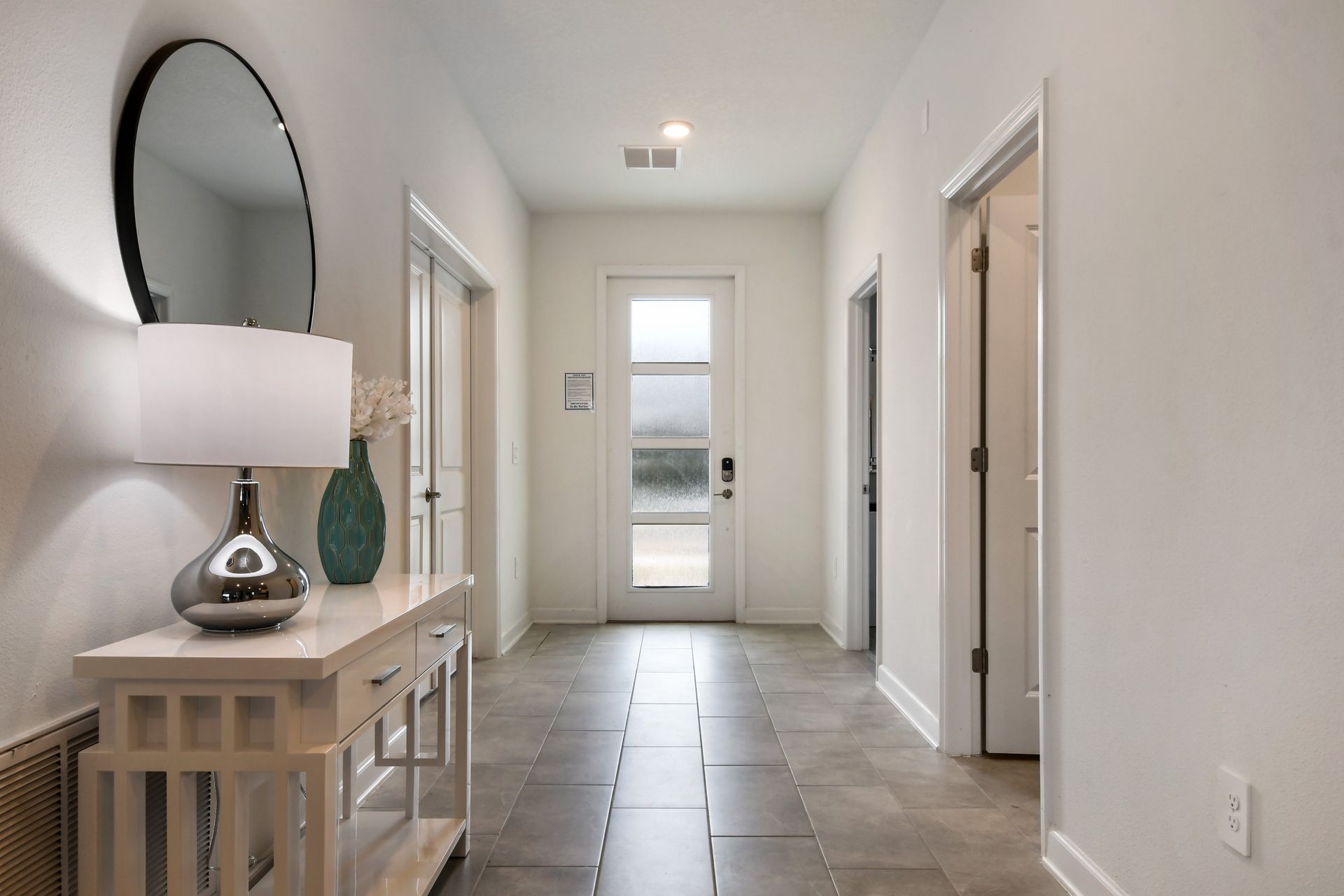 Bright, modern entryway with elegant decor welcomes you to your stylish stay.