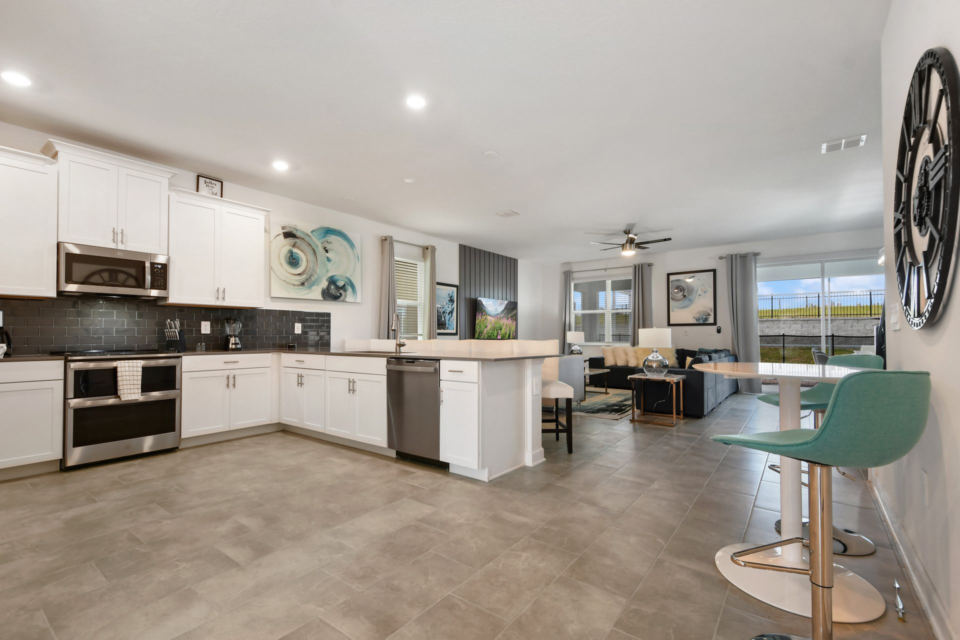 Spacious open kitchen and living area with modern decor and plenty of seating.