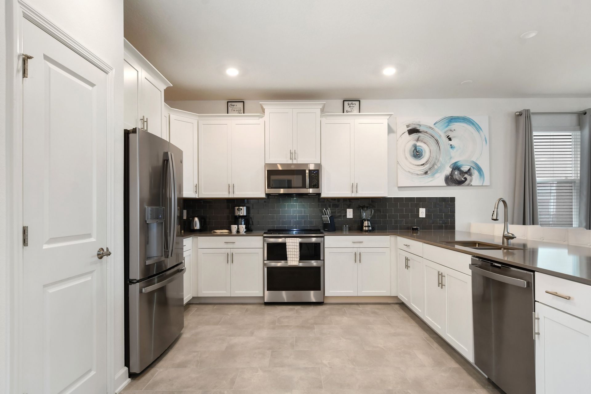 Modern chef’s kitchen with stainless steel appliances, sleek counters, and style.