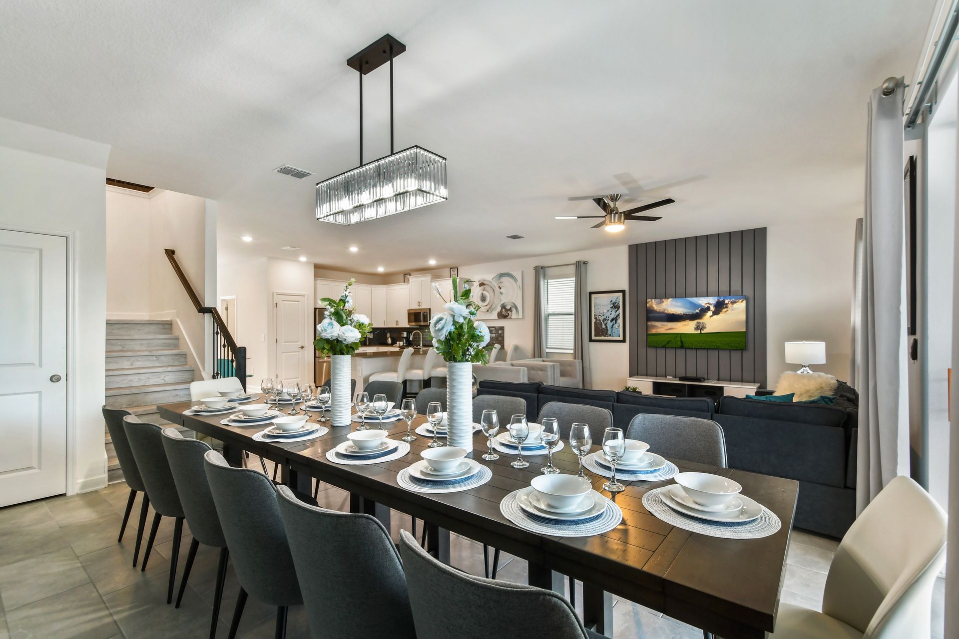 Designer dining and living space with seating for 12, smart TV, and luxe finishes.