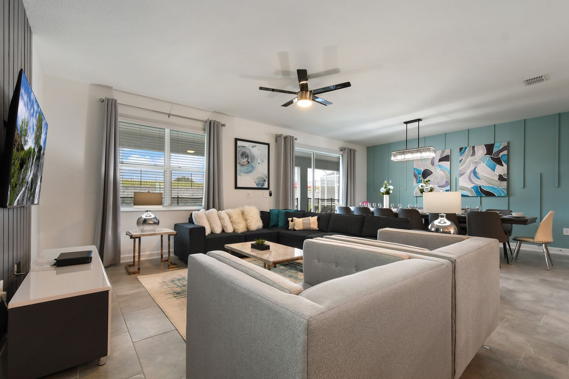 Modern open-plan lounge and dining area with sleek finishes and ample seating.