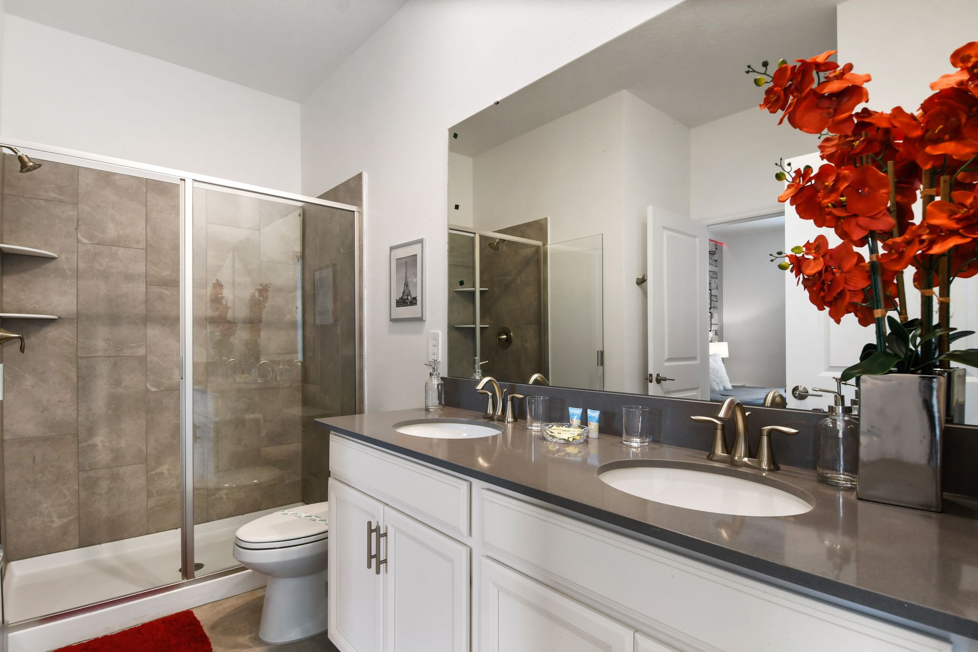 Stylish double-vanity bathroom with a sleek glass shower and modern touches.