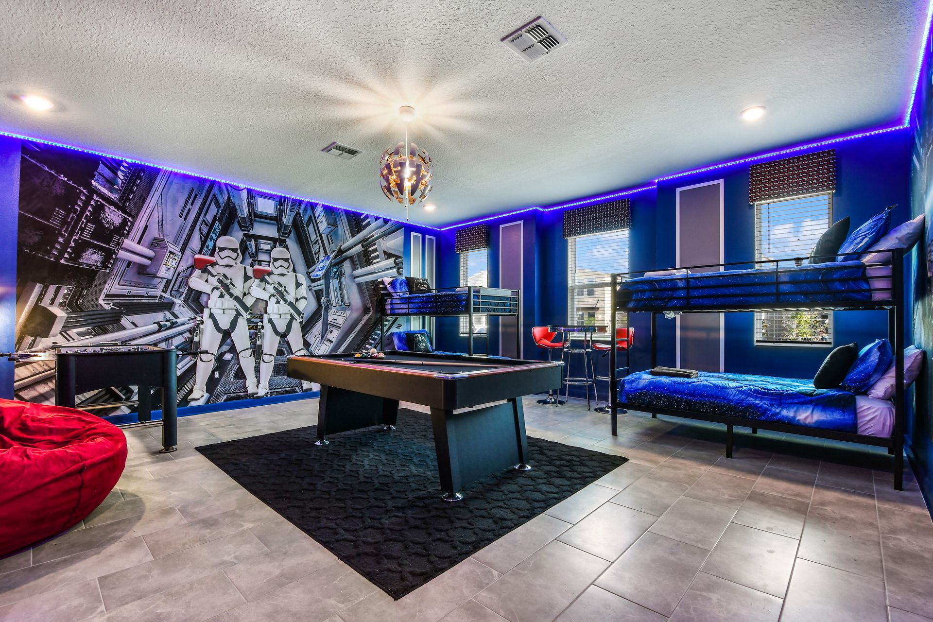 Epic galactic game room with bunk beds, pool table, foosball, and LED lighting.

