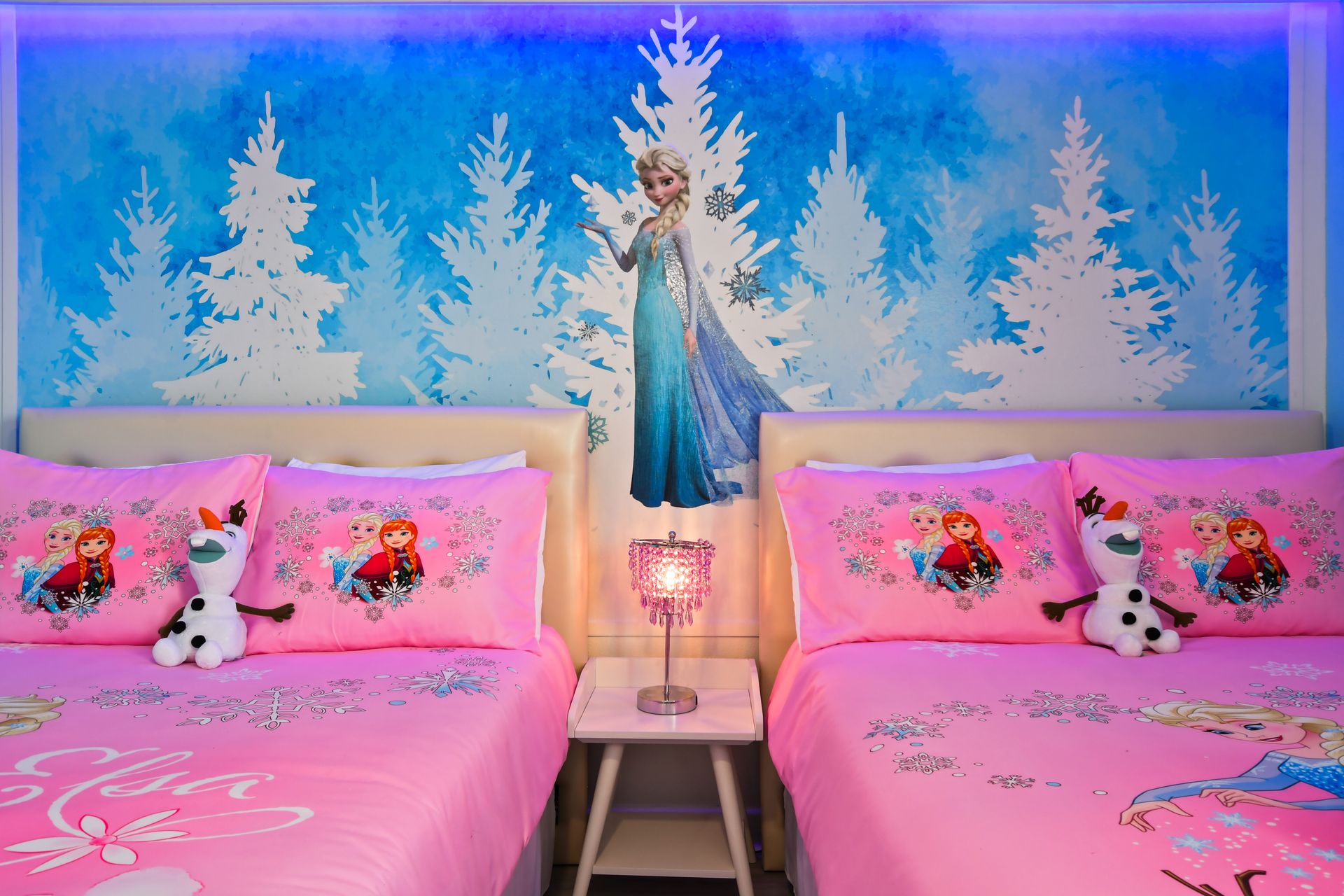 Magical winter princess room with themed bedding, chandelier, and icy wall art.