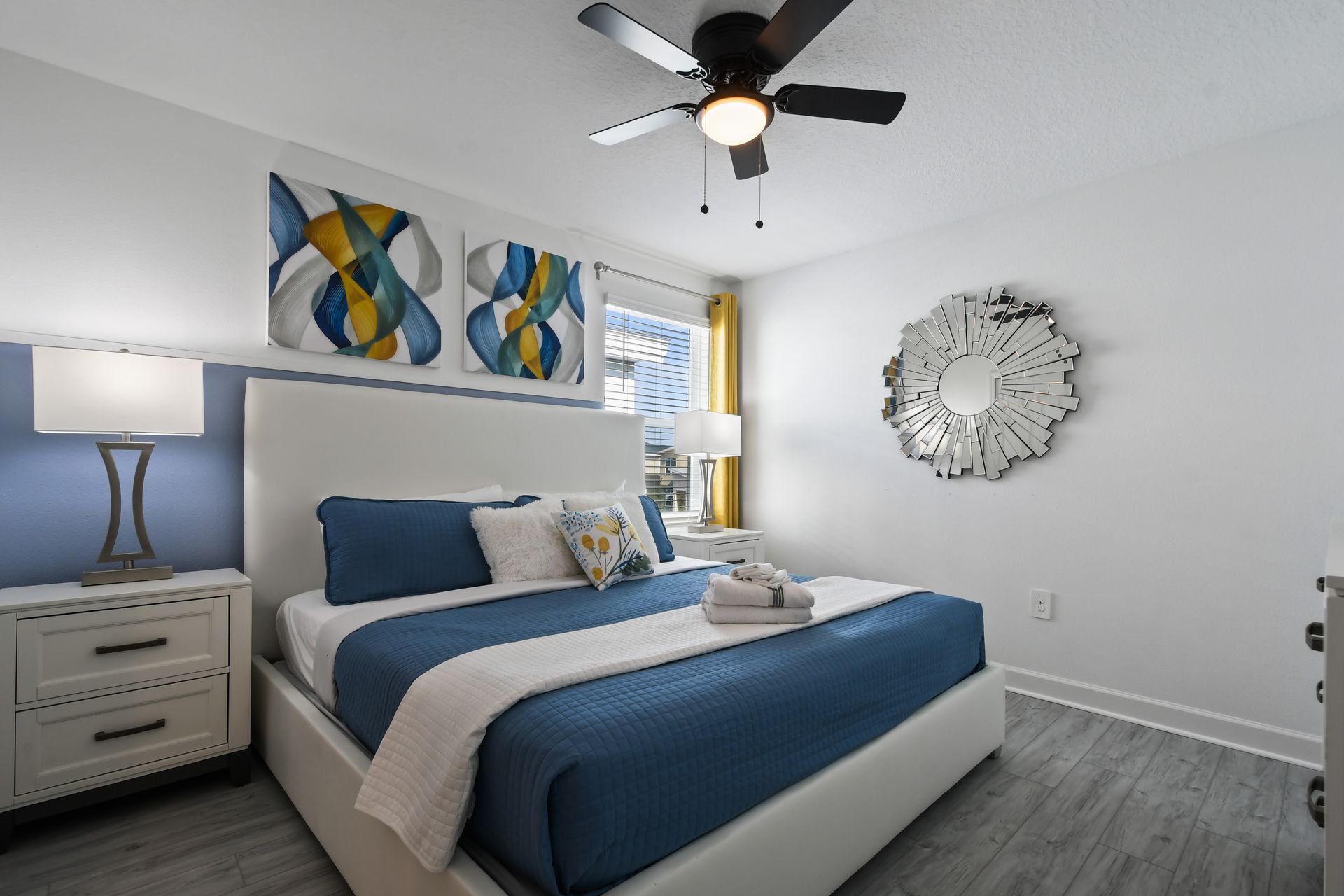Bright modern bedroom with king bed, bold accents, and artistic contemporary flair.