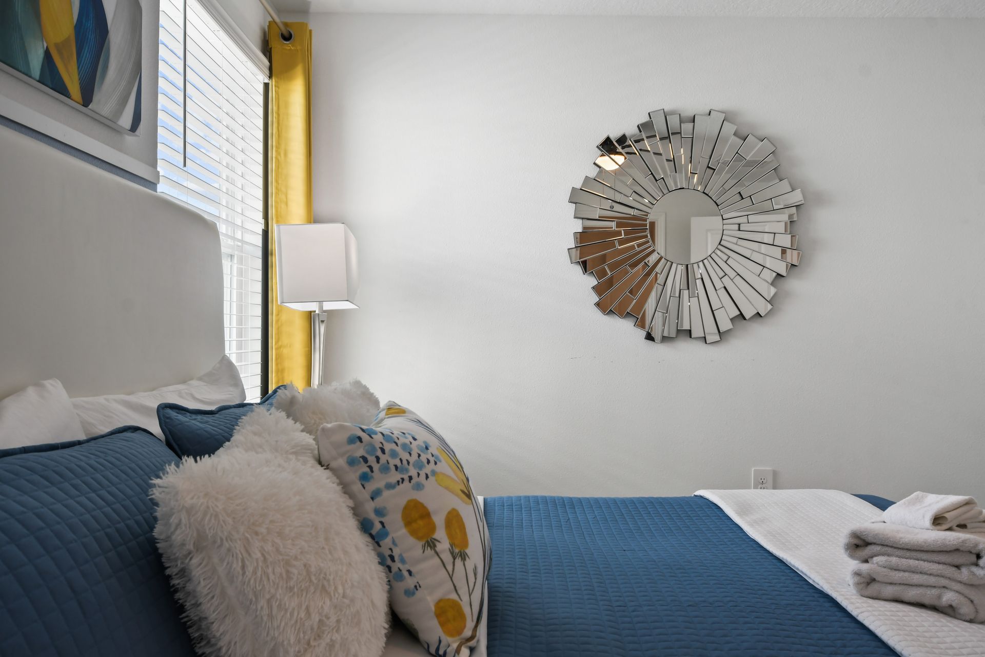 Bright modern bedroom with king bed, bold accents, and artistic contemporary flair.