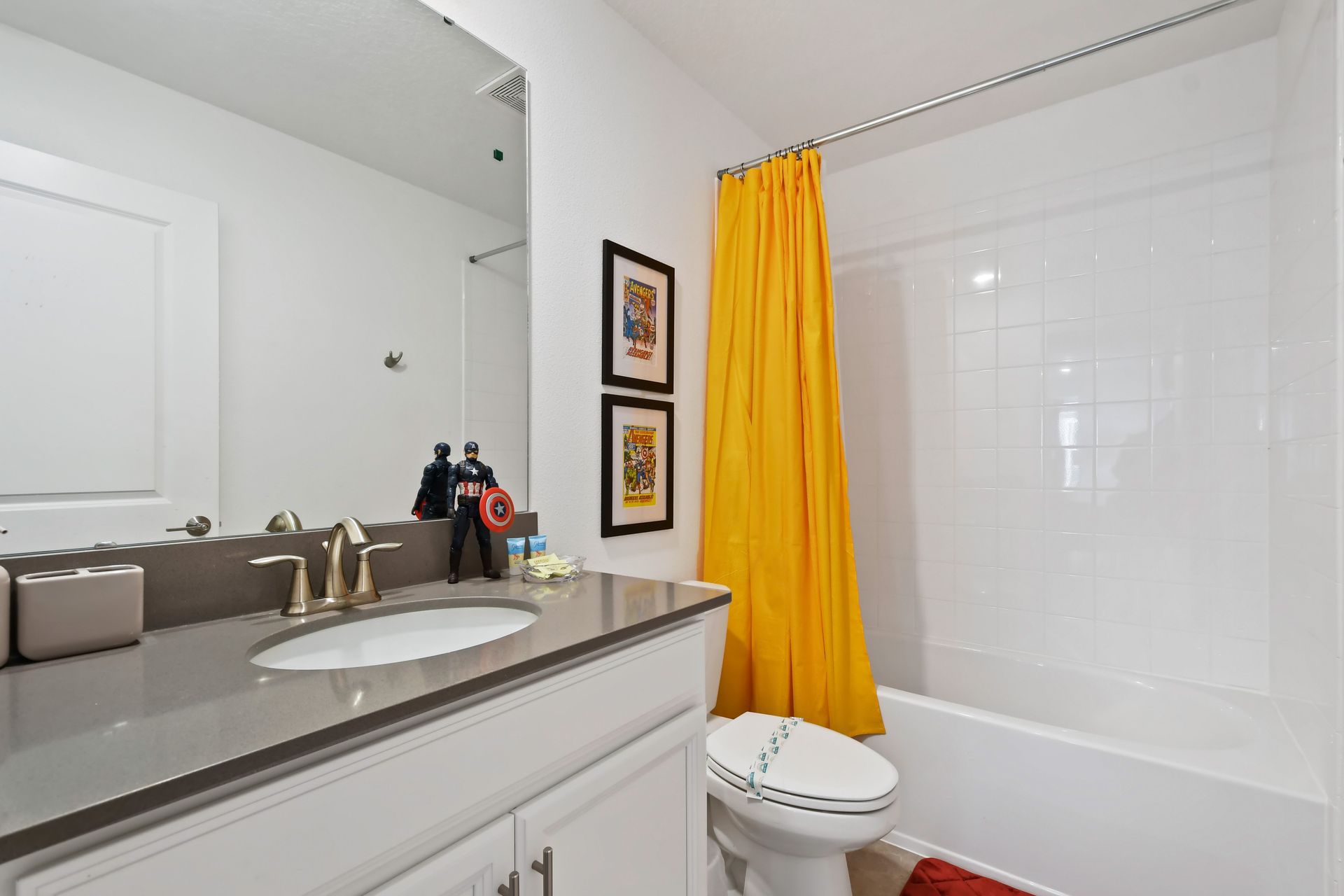 Fun superhero-themed bathroom with bright accents and a clean modern layout.
